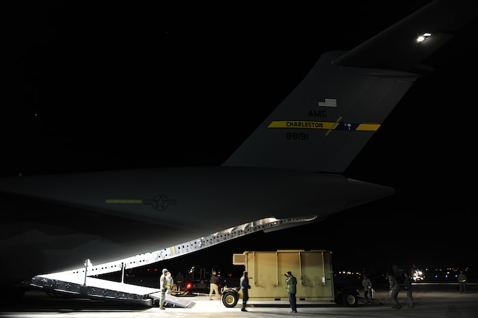 U.S. Air Force personnel from the 621st   Contingency Response Wing, Joint Base McGuire-Dix-Lakehurst, N.J., load cargo onto a Charleston Air Force Base, S.C., C-17 Globemaster III, supporting a swift and coordinated relief effort to Haiti, Jan. 14, 2010, in the aftermath of a devastating earthquake.  (U.S. Air Force photo by Staff Sgt. Joshua L. DeMotts) (Released)
