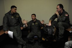 U.S.Air Force Reservists (from left to right) Master Sgt. Michael Lang, Maj. John Cousins, and Maj. Mark Smith with the 317th Airlift Squadron, 437th Air Mobility Wing, Charleston Air Force Base, S.C., conduct a crew brief prior to participating in a swift and coordinated relief effort to Haiti, Jan.14,2010, in the aftermath of a devastating earthquake.  (U.S. Air Force photo by Staff Sgt. Joshua L. DeMotts) (Released)