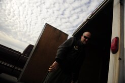 U.S. Air Force Maj. Charles Perreault, a reservist with the 317th Airlift Squadron, 437th Air Mobility Wing, Charleston Air Force Base, S.C., loads his personal gear onto a trailer before participating in a swift and coordinated relief effort to Haiti, Jan.14, 2010, in the aftermath of a devastating earthquake.  (U.S. Air Force photo by Staff Sgt. Joshua L. DeMotts) (Released)