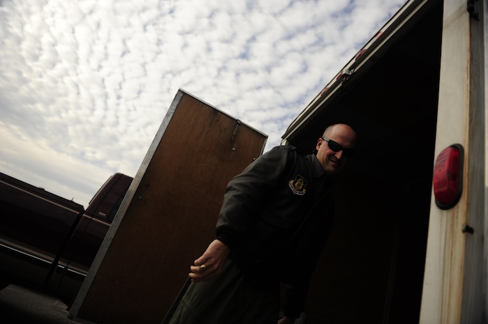 U.S. Air Force Maj. Charles Perreault, a reservist with the 317th Airlift Squadron, 437th Air Mobility Wing, Charleston Air Force Base, S.C., loads his personal gear onto a trailer before participating in a swift and coordinated relief effort to Haiti, Jan.14, 2010, in the aftermath of a devastating earthquake.  (U.S. Air Force photo by Staff Sgt. Joshua L. DeMotts) (Released)