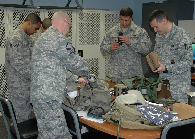 Air Force reservists from the 919th Security Forces Squadron's Deployed Air Ground Response Element conduct function checks of their equipment Jan. 14, hours before departing on a mission in support of humanitarian relief efforts for the earthquake-stricken nation of Haiti.  Duke Field's 919th Special Operations Wing is participating in Air Force Special Operations Command's rapid response effort to deliver U.S. military personnel and equipment to the impacted region. (U.S. Air Force photo/Dan Neely)