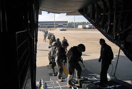 Members of the 82nd Airborne Division, Fort Bragg make their way onto a C-130 on Pope Air Force Base, Jan. 14. The Soldiers are being transported by the 440th Airlift Wing to Port-au-Prince, Haiti to support Humanitarian relief efforts and provide essential airfield security after a 7.0-magnitude earthquake struck the Caribbean nation Jan 12. The efforts of the mission personnel will ensure the safety of future relief operations. (U.S. Air Force photo/Senior Airman Kris Levasseur)