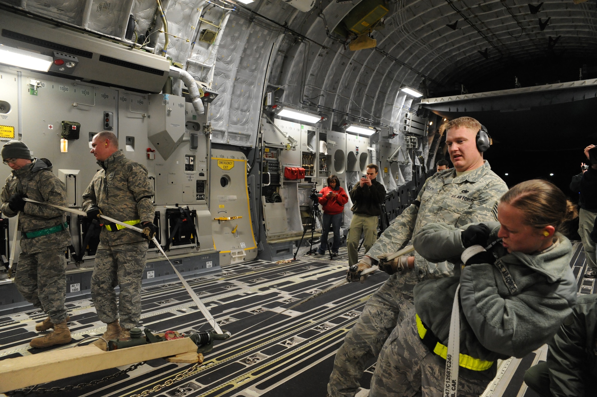 Members of the 305th Aerial Port Squadron load a mobile command and control unit onto C-17 Joint Base McGuire-Dix-Lakehurst, New Jersey, Jan. 15, 2010. Air Mobility Command is responding with all necessary forces and equipment to aide the humanitarian efforts in Haiti. (U.S. Air Force photo/Senior Airman Katie Gieratz)(RELEASED)