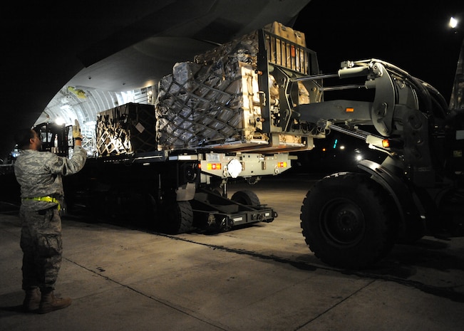 Equipment is unloaded from a Charleston C-17 in Port-au-Prince, Haiti, Jan. 15, 2010. The supplies are a continuous flow from Air Mobility Command to respond to the humanitarian effort in Haiti. (U.S.Air Force photo/Senior Airman Katie Gieratz)(RELEASED)
