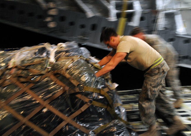 Staff Sgt. Caleb Carmody helps to unload supplies from a Charleston C-17 in Port-au-Prince, Haiti Jan. 15, 2010. Air Mobility Command is participating in a swift and coordinated relief effort to save lives and alleviate human suffering in the aftermath of the earthquake. Sergeant Barmody is an air transportation journeyman with the 817th Global Mobility Squadron. (U.S. Air Force photo/Senior Airman Katie Gieratz)(RELEASED)