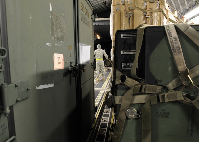 An Airman waits for equipment to be loaded onto a Charleston AFB C-17 at Joint Base McGuire-Dix-Lakehurst, New Jersey, Jan. 15, 2010. The Charleston C-17 was used to transport equipment needed to aid the humanitarian effort in Haiti. (U.S. Air Force photo/Senior Airman Katie Gieratz)(RELEASED)