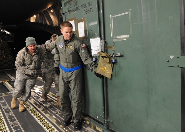 Airmen load equipment onto a Charleston C-17 Joint Base McGuire-Dix-Lakehurst, New Jersey, Jan. 15, 2010. The Charleston C-17 was used to transport equipment needed to aid the humanitarian effort in Haiti. (U.S. Air Force photo/Senior Airman Katie Gieratz)(RELEASED)