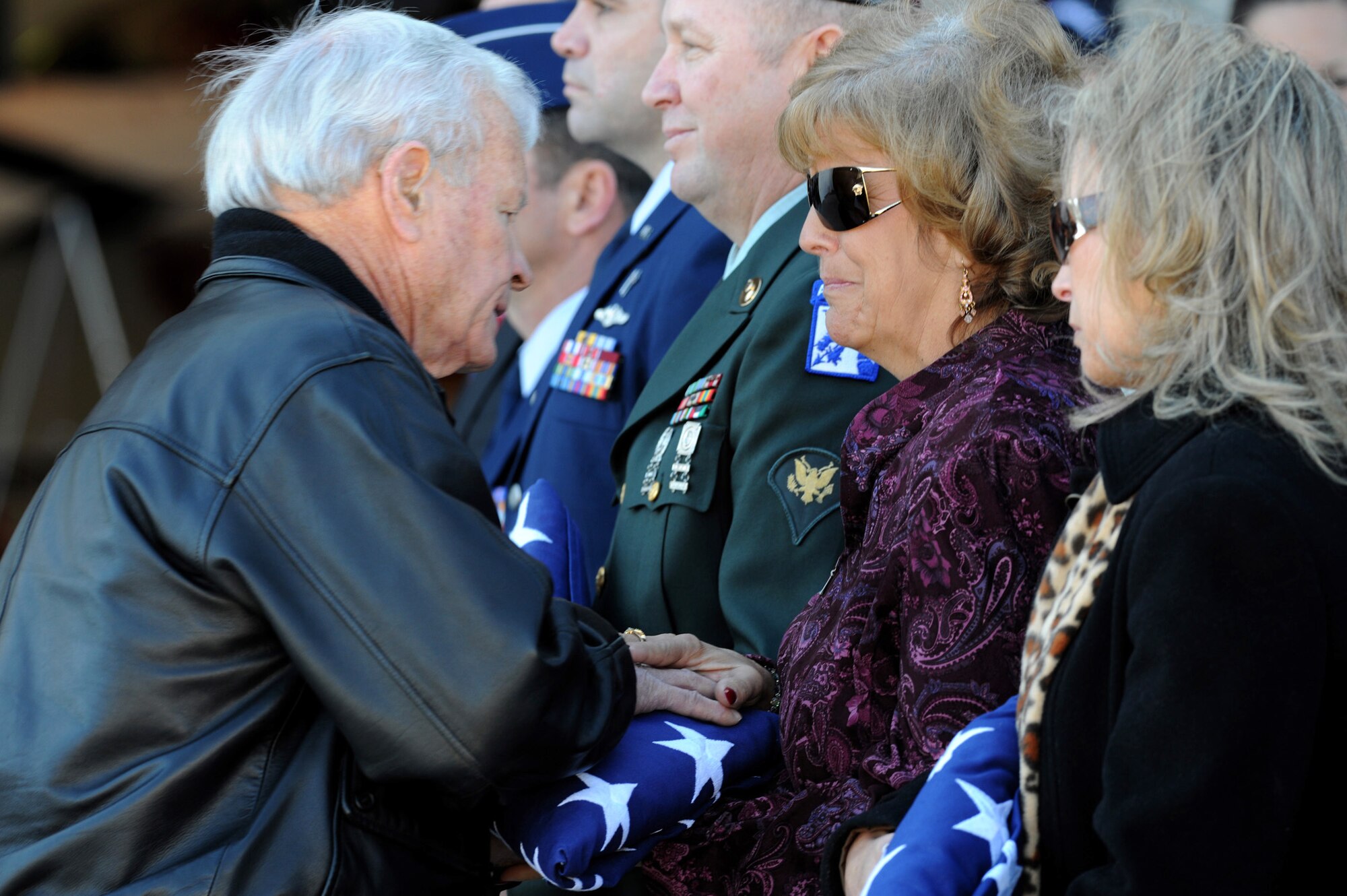 Former Thunderbird commander retired Brig. Gen. Paul A. Kauttu presents a folded American flag to Christine Stonebraker during the repatriation and funeral ceremony for Maj. Russel C. Goodman at the Thunderbird hanger Jan. 14, 2010, at Nellis Air Force Base, Nev. Mrs. Stonebraker is the daughter of Major Goodman, who served as the narrator for the Air Force Thunderbirds from 1964 to 1965 and was declared missing in action after his aircraft was hit by a surface-to-air missile in February 1967 while on a combat mission over North Vietnam. (U.S. Air Force photo/Tech. Sgt. Michael R. Holzworth) 