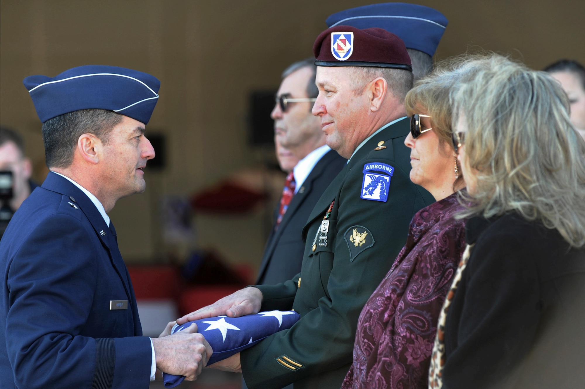 Brig. Gen. Russell J. Handy presents former Army Spc. Russell Goodman, son of Maj. Russell C. Goodman, an American flag during the repatriation and funeral service for Major Goodman Jan. 14, 2010, at Nellis Air Force Base, Nev. Major Goodman served as the narrator for the Air Force Thunderbirds from 1964 to 1965 and was declared missing in action after his aircraft was hit by a surface-to-air missile in February 1967 while on a combat mission over North Vietnam. General Handy is the 57th Wing commander. (U.S. Air Force photo/Lawrence Crespo)
