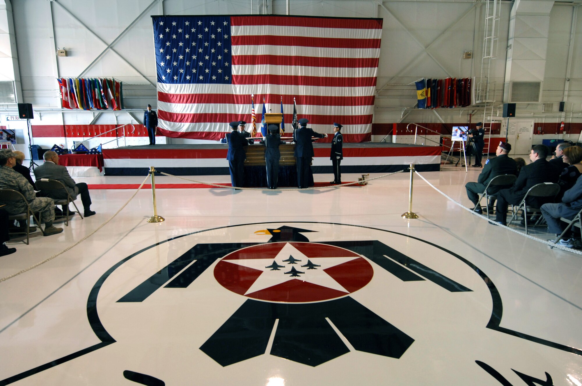 Honor guard members prepare to fold the American flag during the repatriation and funeral service for Maj. Russell C. Goodman Jan. 14, 2010, at Nellis Air Force Base, Nev. Major Goodman served as the narrator for the Air Force Thunderbirds from 1964 to 1965 and was declared missing in action after his aircraft was hit by a surface-to-air missile in February 1967 while on a combat mission over North Vietnam. (U.S. Air Force photo/Lawrence Crespo)