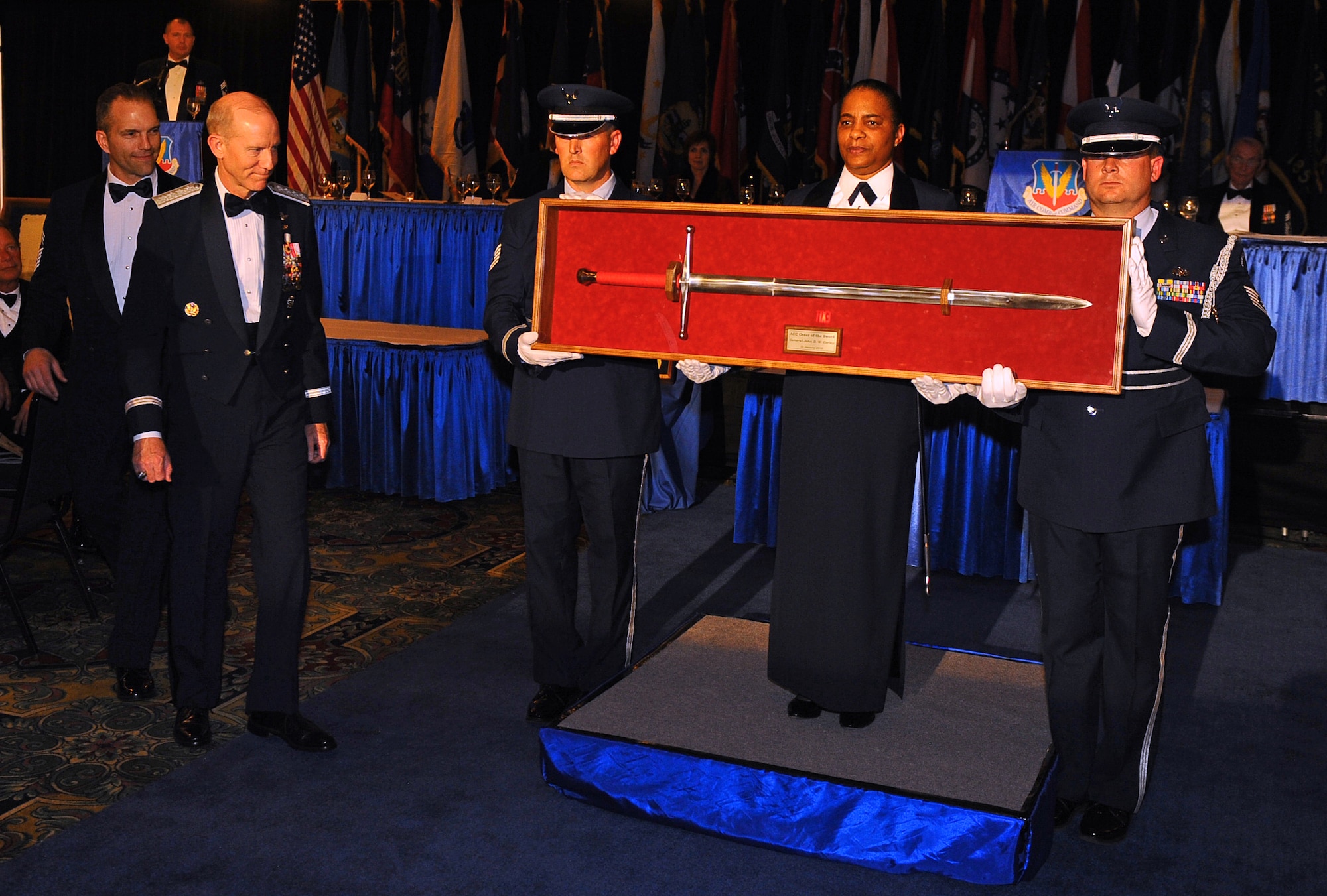 OFFUTT AIR FORCE BASE, Neb. - Retired Gen. John D.W. Corley, former commander of Air Combat Command, accepts a shadowbox containing a sword during an Order of the Sword Ceremony in his honor at the Doubletree Hotel in Omaha, Neb., Jan. 13.  The Order of the Sword  is the highest honor awarded by the U.S. Air Force enlisted corps.

U.S. Air Force photo by Josh Plueger
