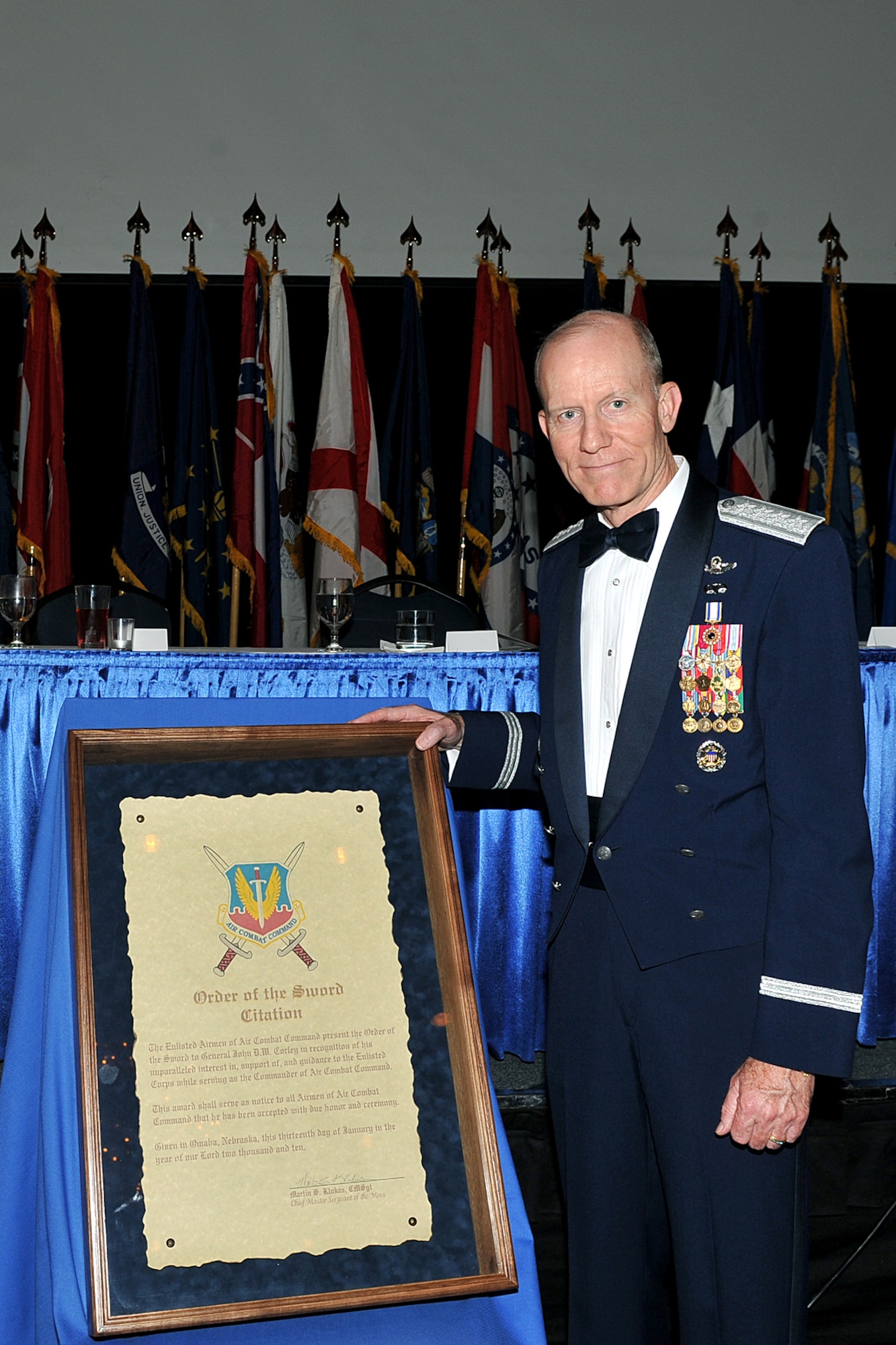 OFFUTT AIR FORCE BASE, Neb. - Retired Gen. John D.W. Corley, former commander of Air Combat Command, poses for a photo by his citation during a special Order of the Sword ceremony at the Doubletree Hotel in Omaha, Neb., Jan. 13. The honor was established by the Air Force enlisted corps to recognize and honor senior officers (colonels or above) and civilian equivalents, for "conspicuous and significant contributions to the welfare and prestige of the enlisted force and mission effectiveness."

U.S. Air Force photo by Charles Haymond

