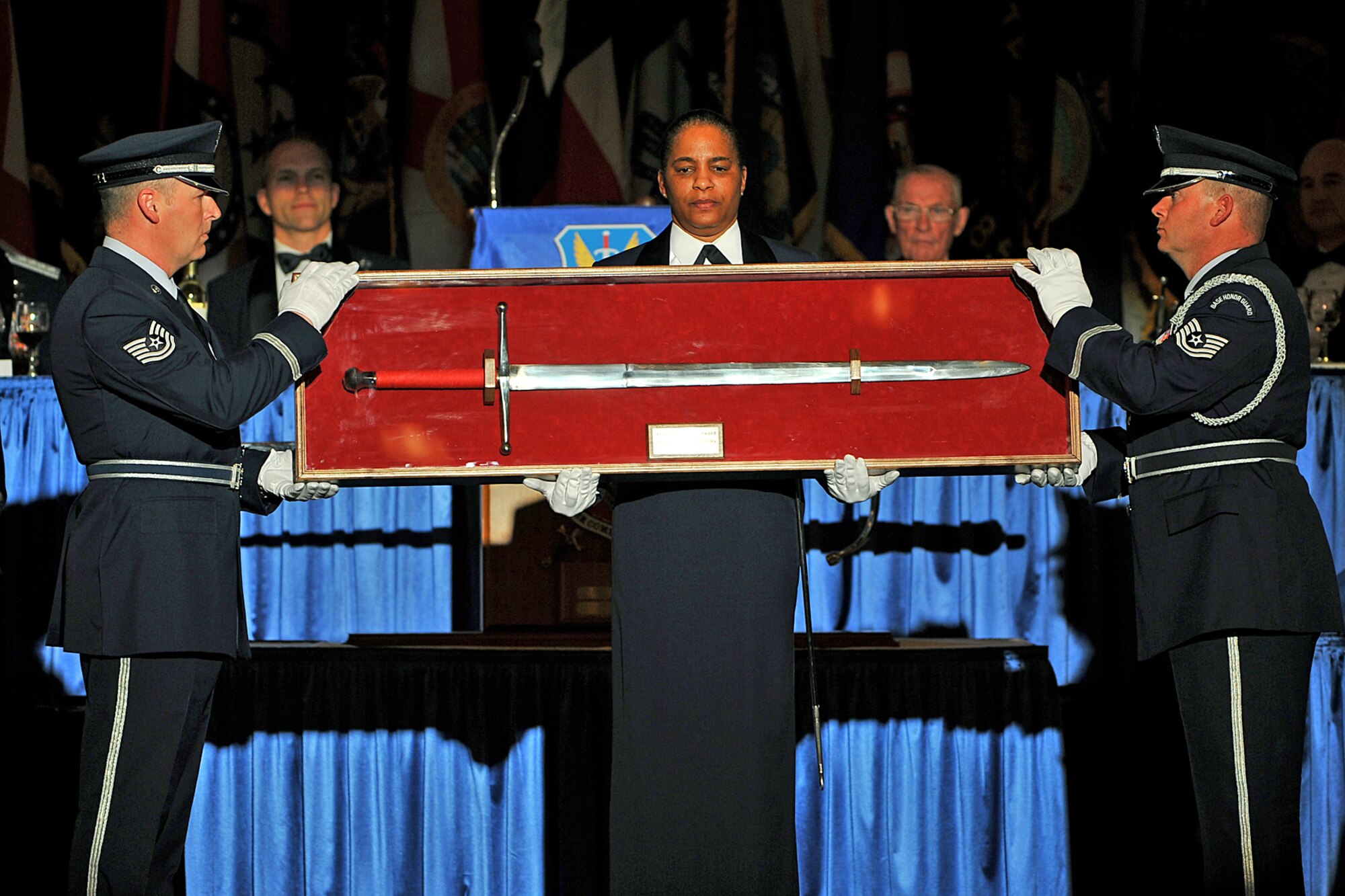 OFFUTT AIR FORCE BASE, Neb. - Technical Sgt. Chris Ellis, superintendent of the Dyess AFB, Texas, honor guard, Chief Master Sgt. Shelina Frey, Langley AFB, Va., Air Combat Command first sergeant, and Tech. Sgt. Troy Bizzack, Holloman AFB, N.M., honor guard non-commissioned officer in change, present the sword during an ACC Order of the Sword ceremony at the Doubletree Hotel in Omaha, Neb., Jan. 13.  The honor was established by the Air Force enlisted corps to recognize and honor senior officers (colonels or above) and civilian equivalents, for "conspicuous and significant contributions to the welfare and prestige of the enlisted force and mission effectiveness."

U.S. Air Force photo by Charles Haymond
