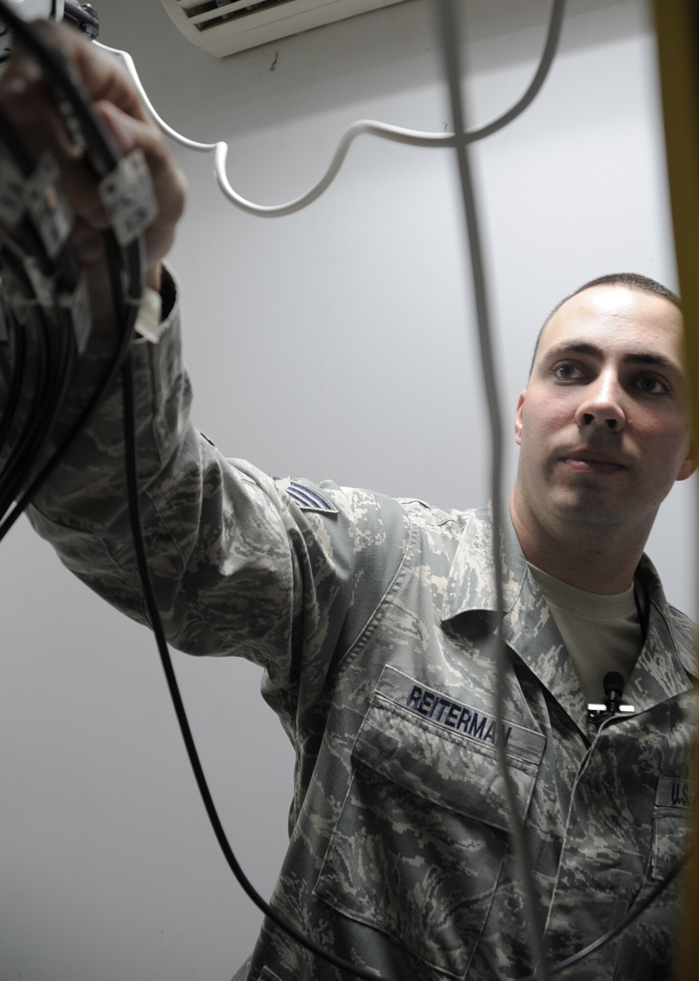 Staff Sgt. Randy Reiterman, cable television engineering and installation craftsman with the 380th Expeditionary Communications Squadron, tests cable mounts in his workcenter Jan. 15, 2010, at a non-disclosed location in Southwest Asia.  Sergeant Reiterman is responsible for supporting the massive networking of television capability across the 380th Air Expeditionary Wing?s infrastructure along with other commercial network support. He is deployed from the 5th Communications Squadron at Minot Air Force Base, N.D., and his hometown is Warren, Mich.  (U.S. Air Force Photo/Tech. Sgt. Scott T. Sturkol/Released)