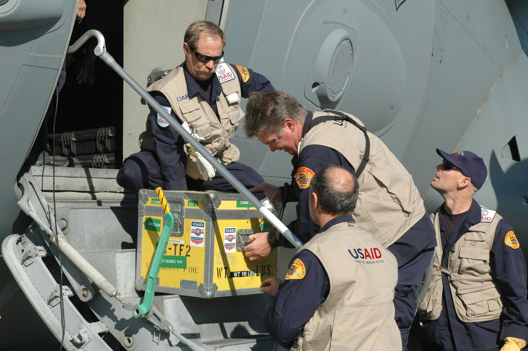 California Task Force 2 members unload humanitarian relief supplies from a C-17 Globemaster III Jan. 14, 2010, in Port-au-Prince, Haiti. (U.S. Air Force photo/2nd Lt. Holly Hess)