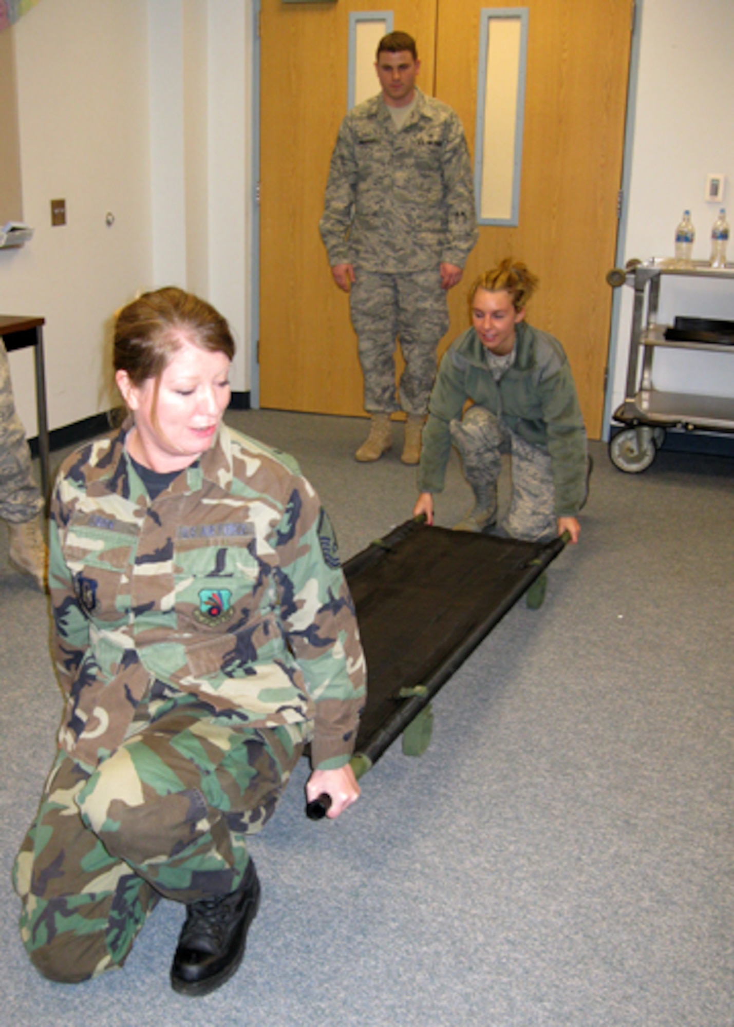 GRISSOM AIR RESERVE BASE, Ind., --  Staff Sgt. Ryan Waddell, a medical services technician with the 434th Aerospace Medicine Squadron, instructs a group of Airmen on the proper techniques of patient transport using a liter.  Master Sgt Audra Turrin (front), a dental technician with the 434th AMDS, and Airman 1st Class Jessamyn Rhymer,  a health services management apprentice, practice the techniques of proper lifting.  (U.S. Air Force photo/ Staff Sgt. Ben Mota)                               