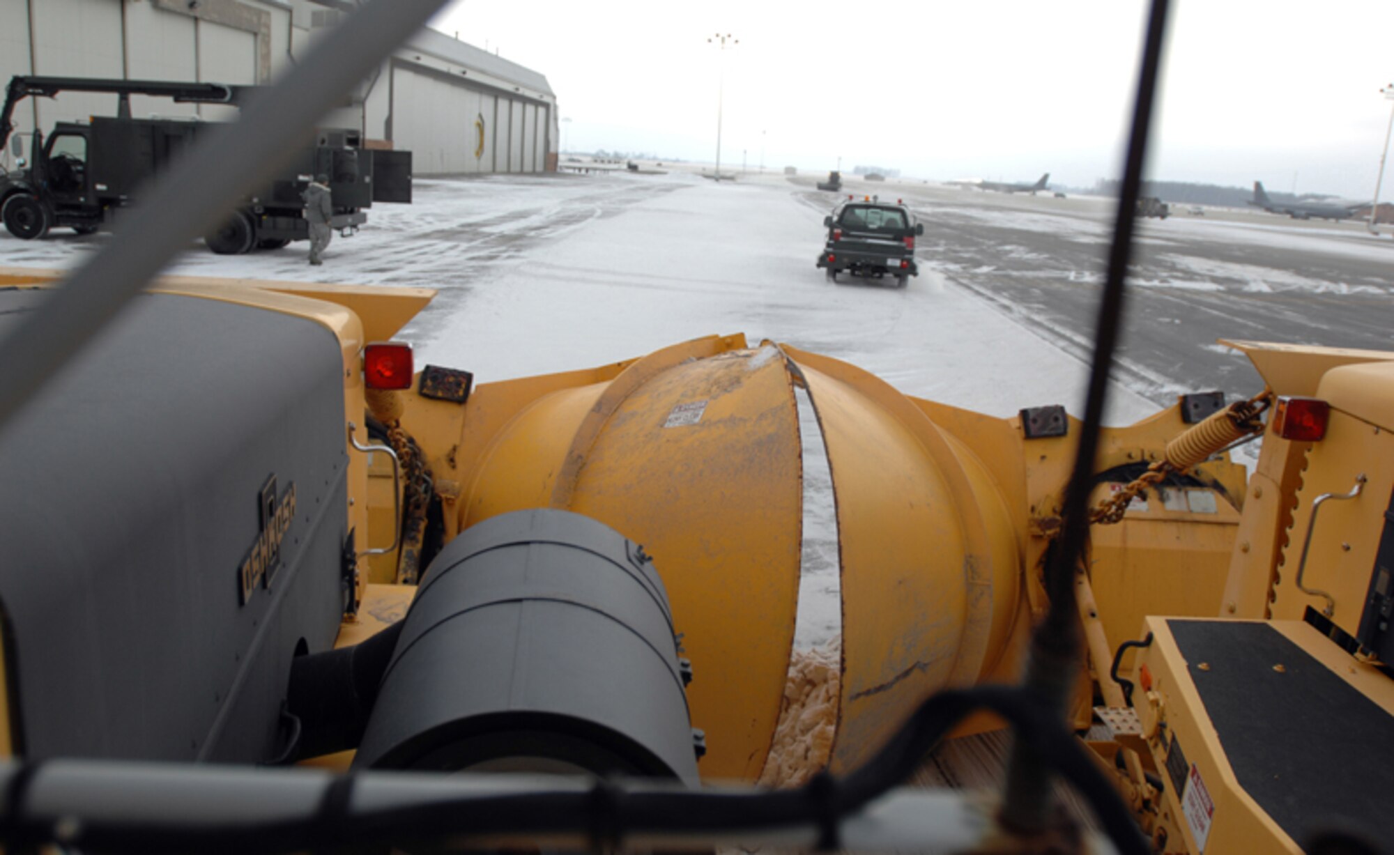 GRISSOM AIR RESERVE BASE, Ind.-- Contractors drive side by side rollover snowplows as this method allows for the runway to be clear much faster. If the runway is icy the contractors will apply potassium acetate, which is a substance that is environmentally friendly and breaks the ice down so that it can be cleared from the runway. (U.S. Air Force photo/Senior Airman Carl Berry)