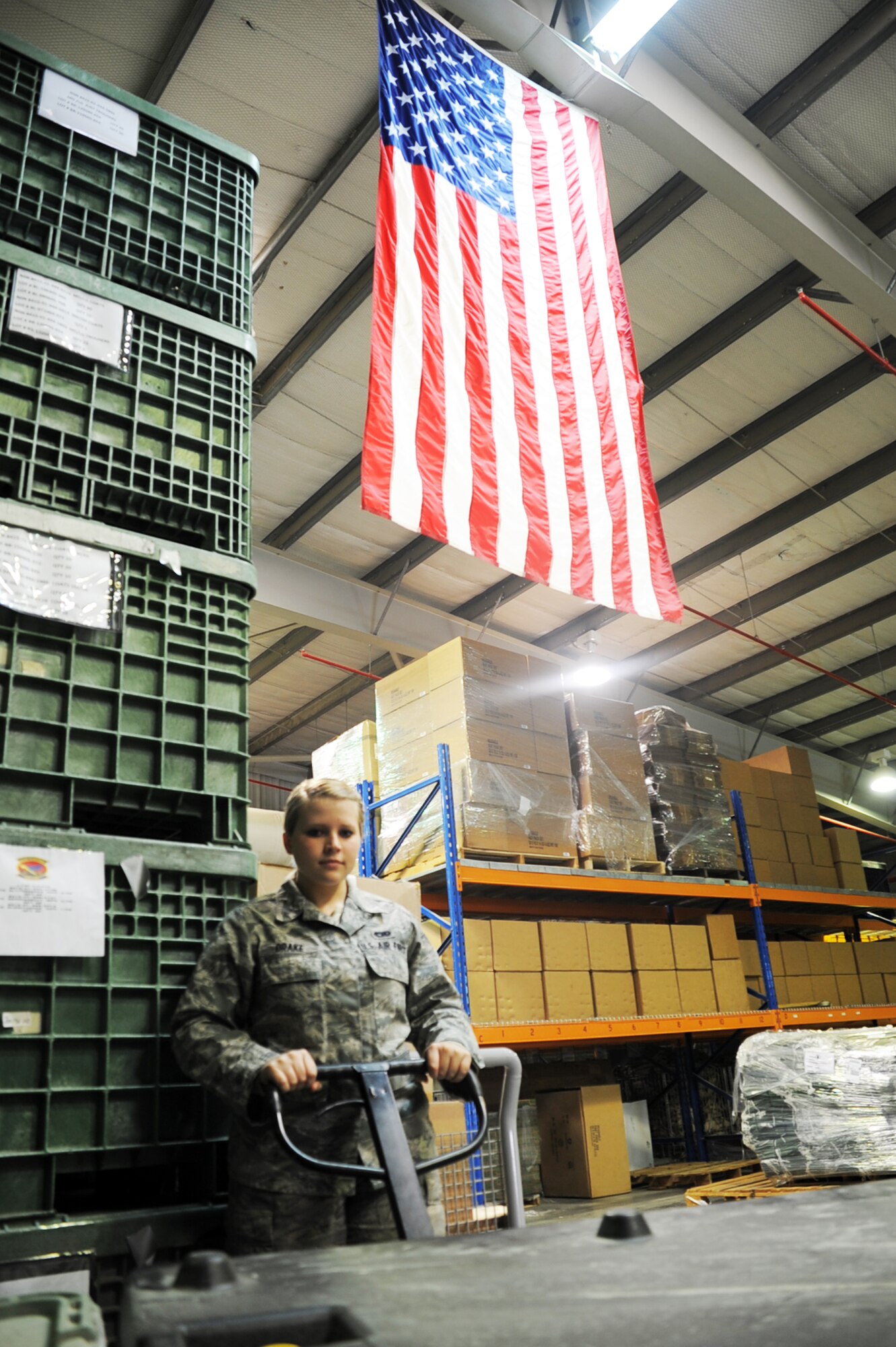 Airman 1st Class Te'Anna R. Drake, a traffic management journeyman with the 380th Expeditionary Logistics Readiness Squadron, moves some cargo into place at her unit's warehouse at an non-disclosed location in Southwest Asia on Jan. 15, 2009.  In her deployed work, Airman Drake packs and ships out official priority shipments to all other bases in the U.S. as well as the deployed area of responsibility. She is deployed from the 60th Aerial Port Squadron at Travis Air Force Base, Calif., and her hometown is Roy, Wash.  (U.S. Air Force Photo/Tech. Sgt. Scott T. Sturkol/Released)