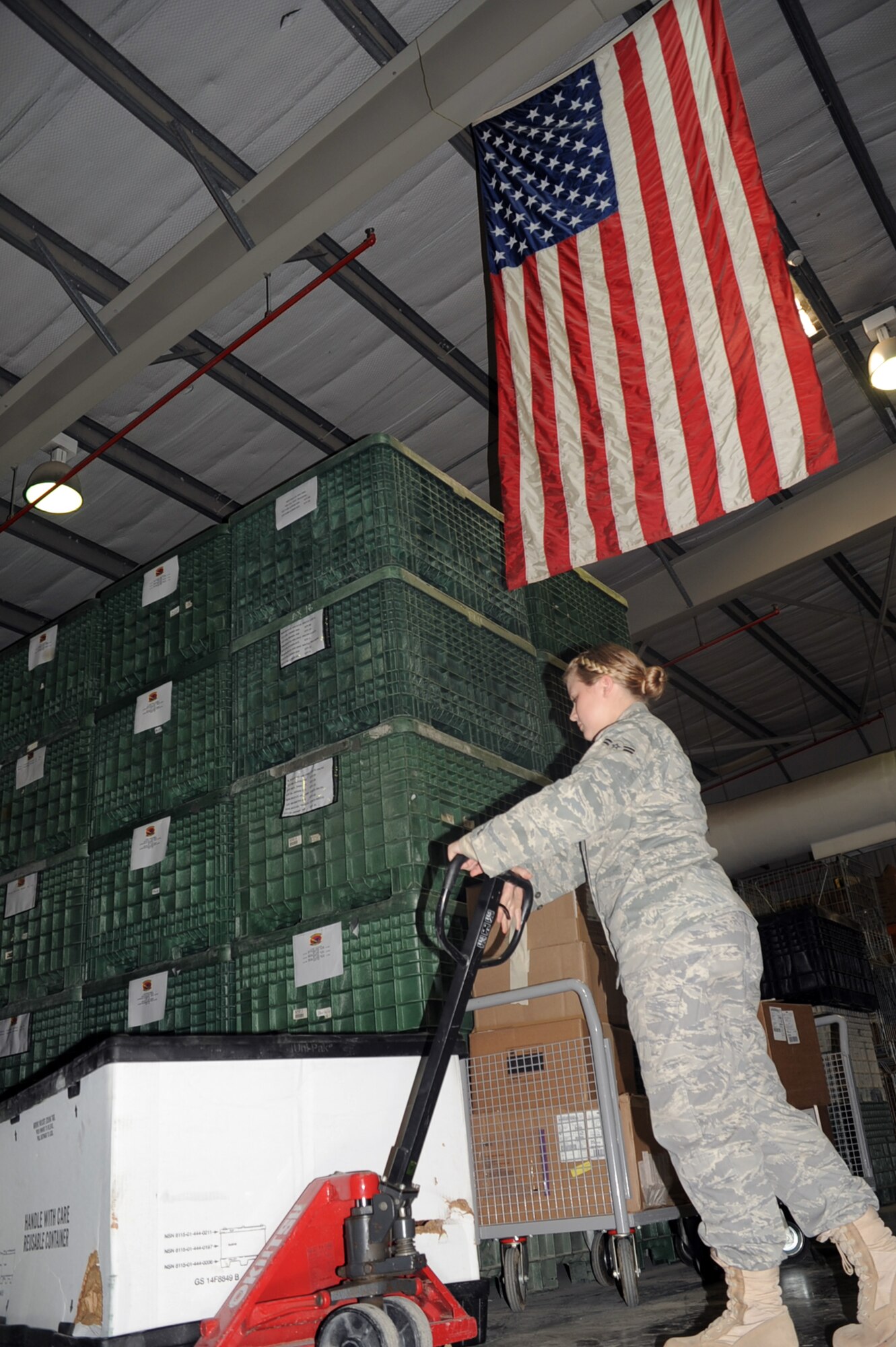 Airman 1st Class Te'Anna R. Drake, a traffic management journeyman with the 380th Expeditionary Logistics Readiness Squadron, moves some cargo into place at her unit's warehouse at an non-disclosed location in Southwest Asia on Jan. 15, 2009.  In her deployed work, Airman Drake packs and ships out official priority shipments to all other bases in the U.S. as well as the deployed area of responsibility. She is deployed from the 60th Aerial Port Squadron at Travis Air Force Base, Calif., and her hometown is Roy, Wash.  (U.S. Air Force Photo/Tech. Sgt. Scott T. Sturkol/Released)