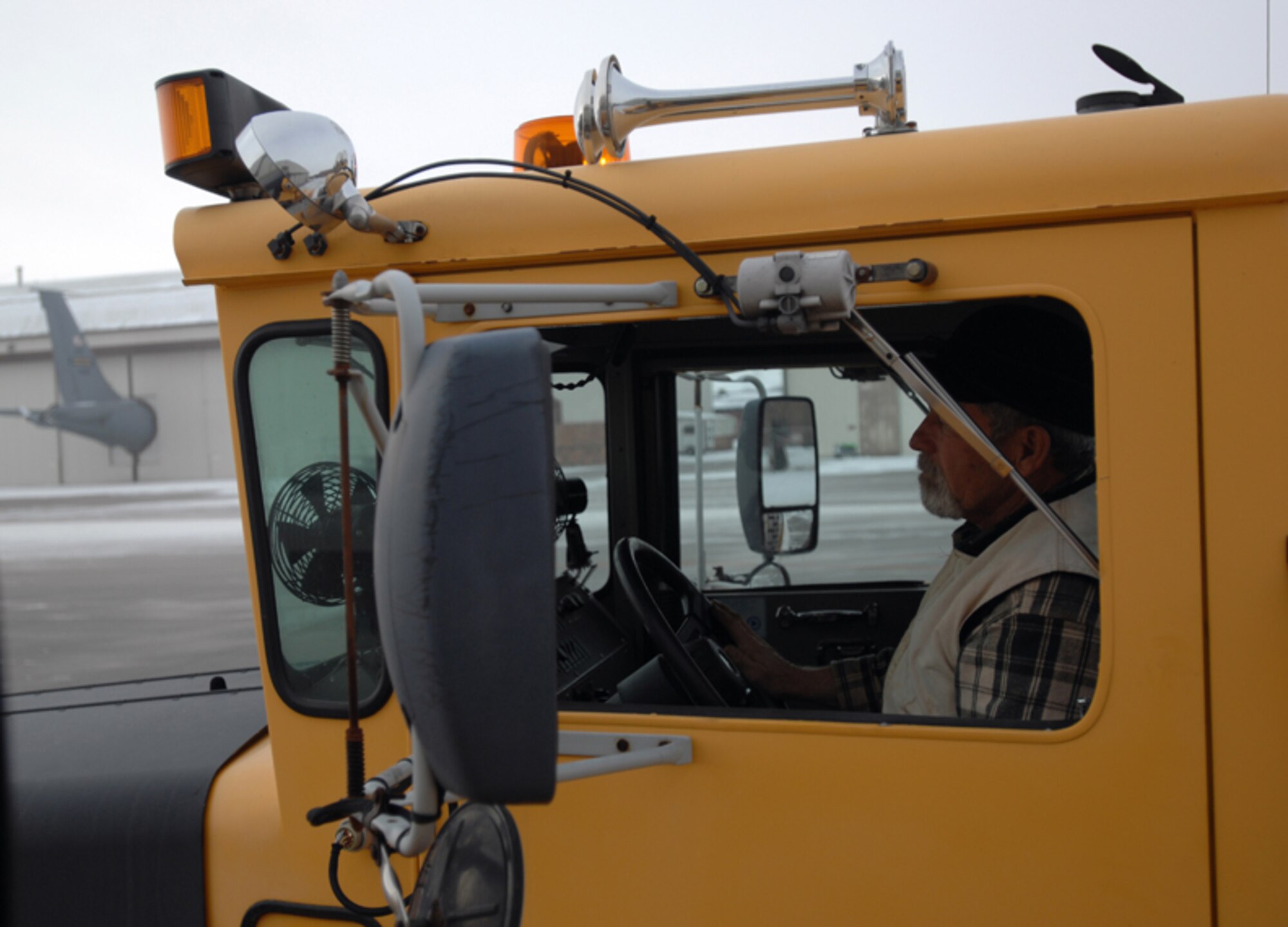 GRISSOM AIR RESERVE BASE, Ind.-- During snow storms contractors perform 24-hour shifts to make sure the runway is clear for take-off and landings in support of Grissom's KC-135R Stratotanker fleet. Here Buck Worland, a Data Monitoring Service employee, operates a rollover snow plow. (U.S. Air Force photo/Senior Airman Carl Berry)