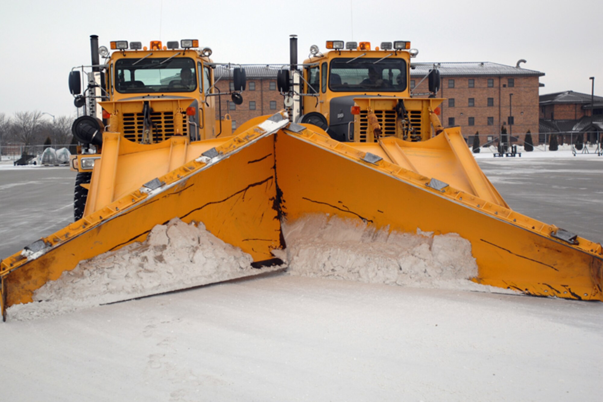 GRISSOM AIR RESERVE BASE, Ind. -- Clearing the runway for take-off and landing is vital to completing the Grissom mission. Here contractors, operating rollover snow plows, work together to keep the runway open. Under ideal conditions it takes an estimated six hours to clear the snow from the entire runway. (U.S. Air Force photo/Senior Airman Carl Berry)