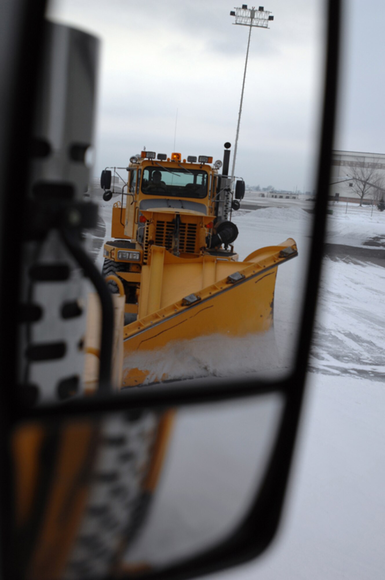 GRISSOM AIR RESERVE BASE, Ind.-- Making sure the runway is clear for take-off and landings is essential to the Grissom mission. During snow falls government contractors are asked to work 24-hour shifts. Here contractors operate rollover snow plows and use a staggered method to clear the runway. Their valuable contributions ensure Grissom is able to meet its mission commitments. (U.S. Air Force photo/Senior Airman Carl Berry)