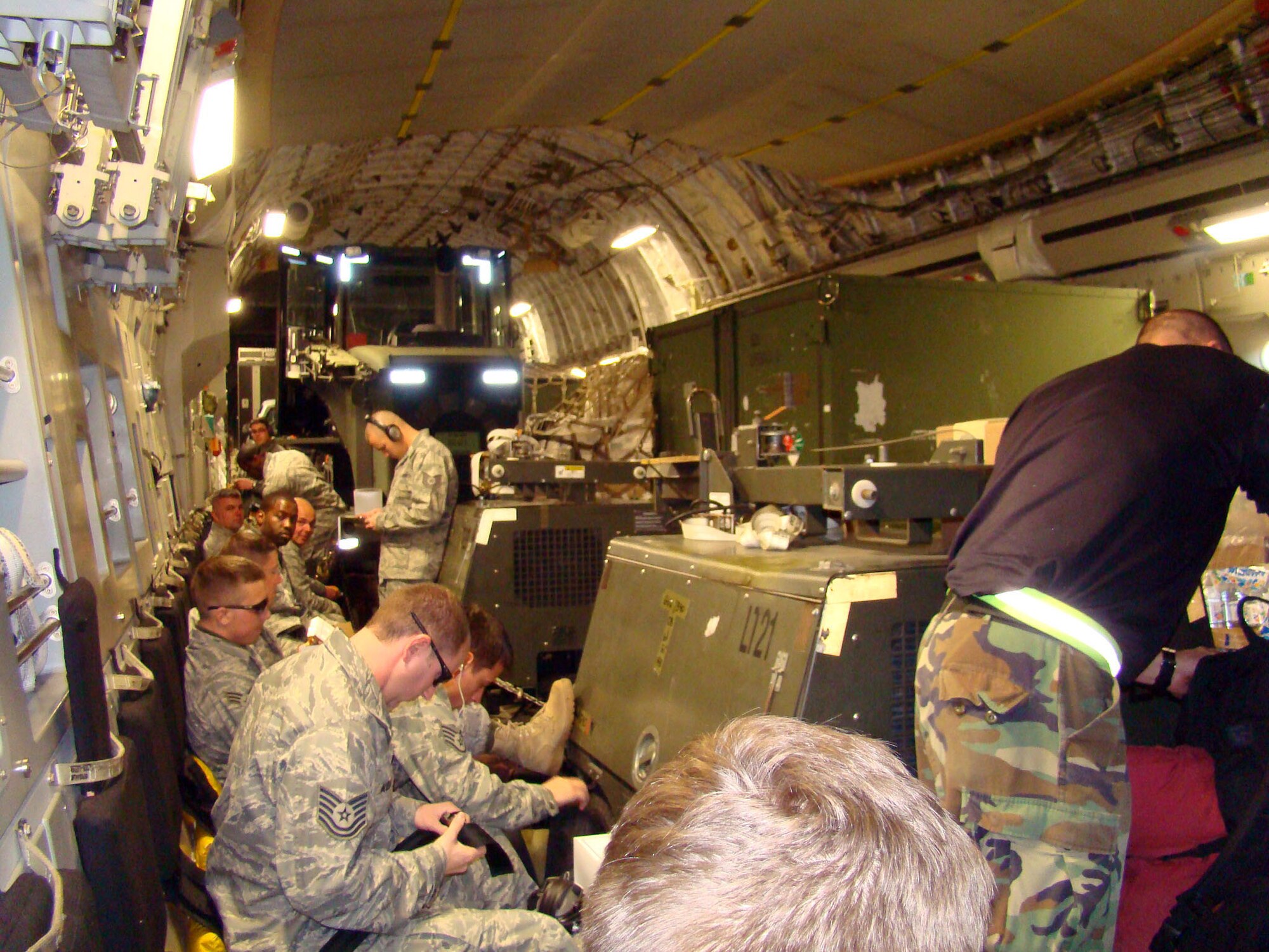 PORT AU PRINCE, Haiti -- Members of the 621st CRW here departed for the Toussaint Louverture International Airport, Haiti, Jan. 14. The 21 passengers squeezed in among 44 tons of cargo being sent to Haiti via a 305th Air Mobility Wing C-17 Globemaster III to support relief operations in response to a devastating earthquake in the area. (U.S. Air Force Photo by Tech. Sgt. Denise Johnson)