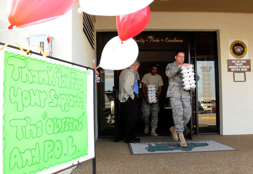 Tech. Sgt. Brent Rouse, 96th Logistics Readiness Squadron, helps carry out orders of pulled pork sandwiches for a fundraiser to raise money for fellow a Airman. The proceeds raised will help offset additional costs the family is incurring while Tech. Sgt. Eric Olafsen undergoes treatment for leukemia at Sacred Heart Hospital in Pensacola, Fla. (U.S. Air Force photo/ Staff Sgt. Stacia Zachary)
