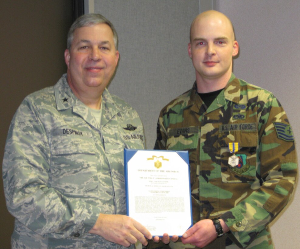 GRISSOM AIR RESERVE BASE, Ind., --  Brig. Gen. Dean J. Despinoy, 434th Air Refueling Wing Commander (left),  presents Tech. Sgt. Adam M. Evans with the Air Force Commendation Medal during a recent ceremony at Grissom ARB.  Sergeant Evans is a legal services journeyman with the 434th ARW Legal Office.  (U.S. Air Force photo/Tech. Sgt. Doug Hays)                   