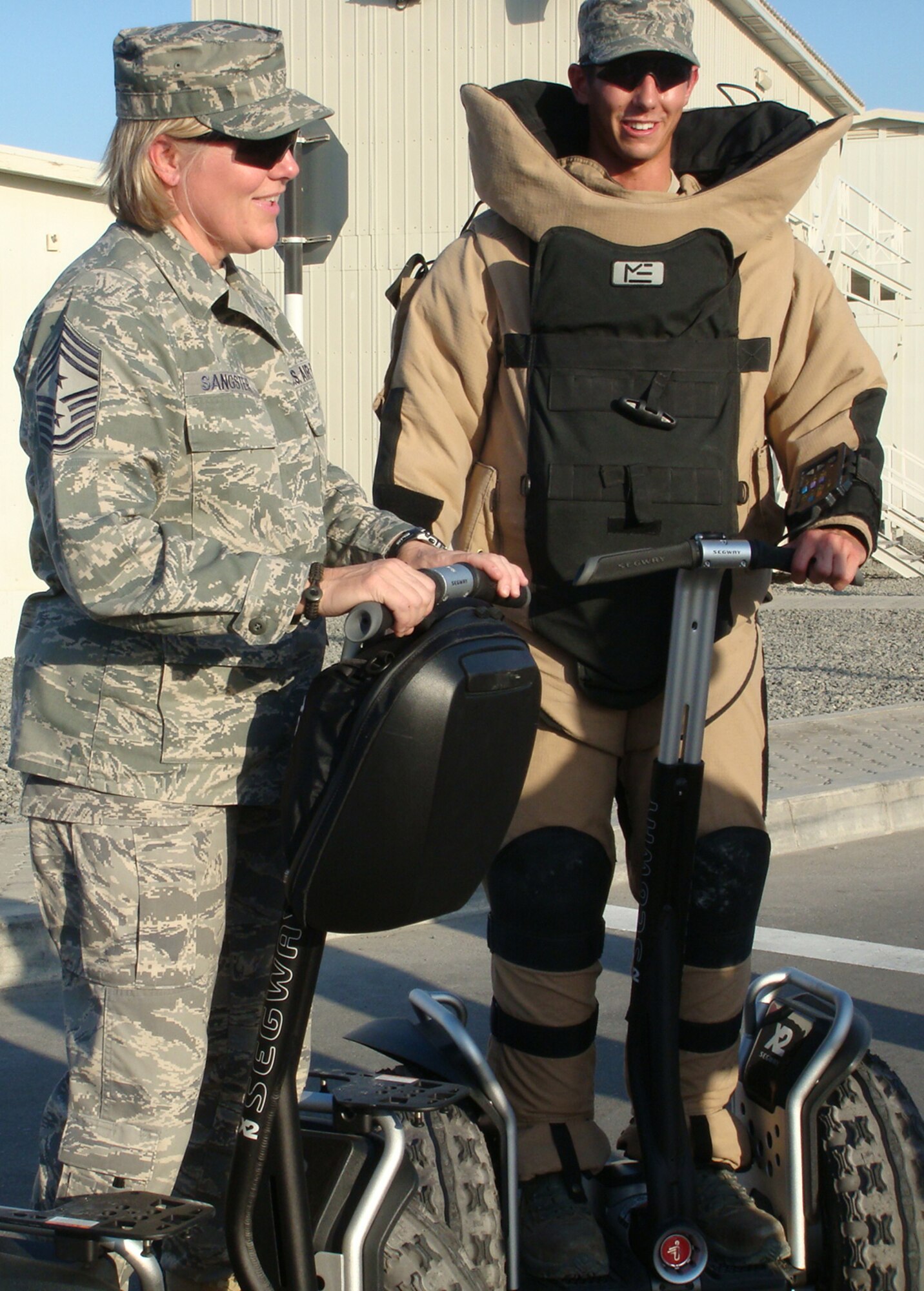 Chief Master Sgt. Suzan K. Sangster (left), command chief master sergeant for the 380th Air Expeditionary Wing, learns about the types of equipment used by 380th Expeditionary Civil Engineer Squadron explosive ordnance disposal Airmen during an event Nov. 26, 2009, at a non-disclosed base in Southwest Asia.  Chief Sangster is a 27-year veteran of the Air Force and is the Air Force's only female command chief for an AEW in the U.S. Central Command area of responsibility.  (U.S. Air Force Photo/Released) 