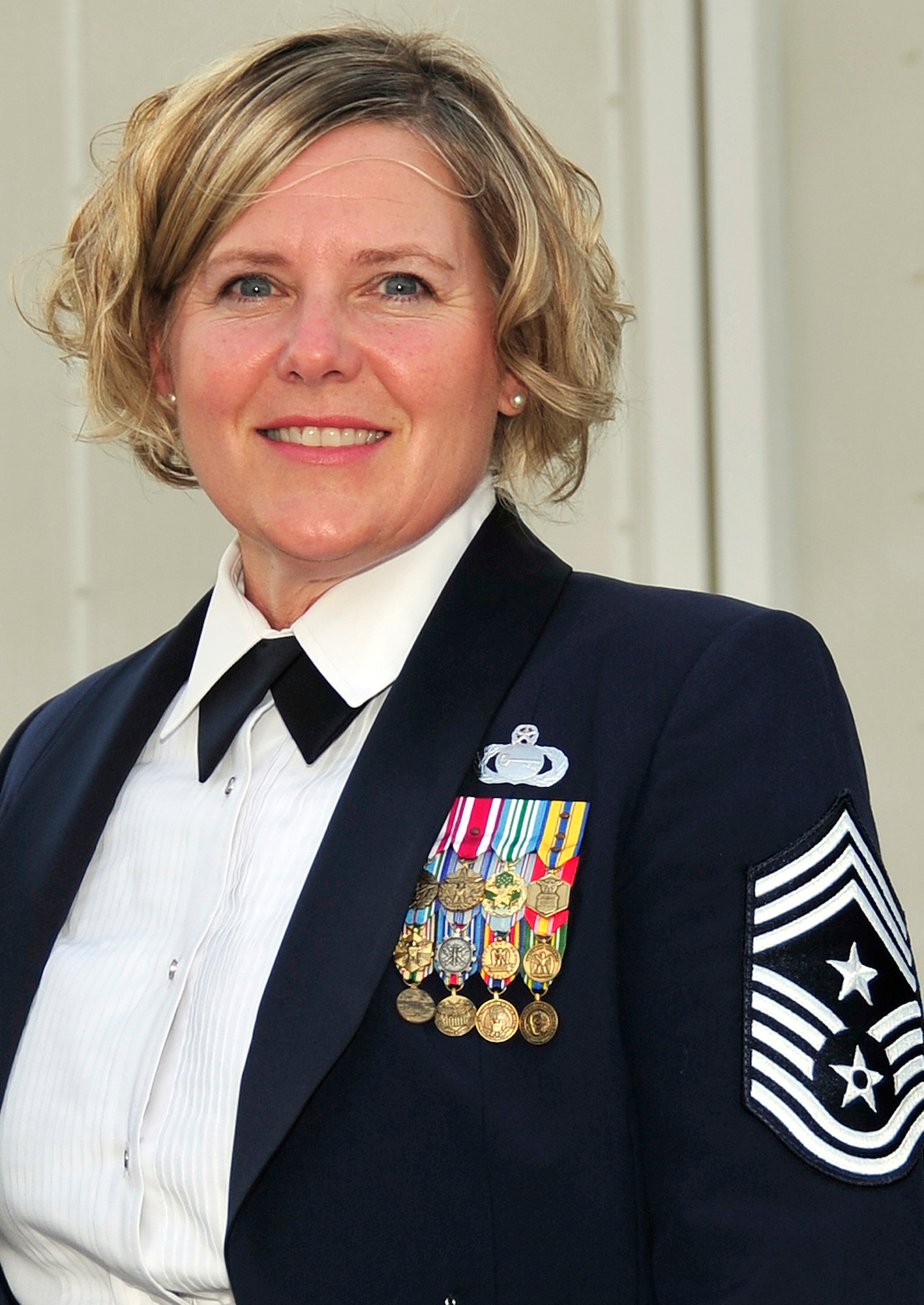 Chief Master Sgt. Suzan K. Sangster, command chief master sergeant for the 380th Air Expeditionary Wing at a non-disclosed base in Southwest Asia, stops for a photo prior to attending a military ball on Nov. 5, 2009.  Chief Sangster is a 27-year veteran of the Air Force and is the Air Force's only command chief master sergeant serving at a deployed wing in the U.S. Central Command area of responsibiltiy.  (U.S. Air Force Photo/Tech. Sgt. Charles Larkin Sr./Released)