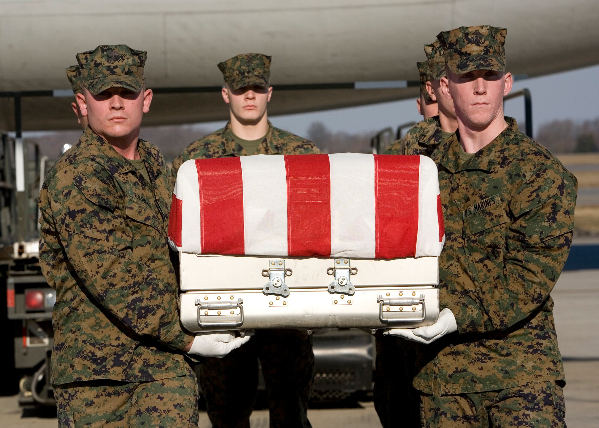 On Jan. 14, 2010 the Marine Corps Carry Team transfers the remains of fallen Marine Staff Sergeant Mathew N. Ingham during a dignified transfer at Dover Air Force Base, Del.  Sergeant Ingham, 25, of Altoona, Pa. died on died Jan. 11 while supporting combat operations in Helmand province, Afghanistan. (USAF Photo by MSgt Vincent De Groot, AFMAO/PA)

