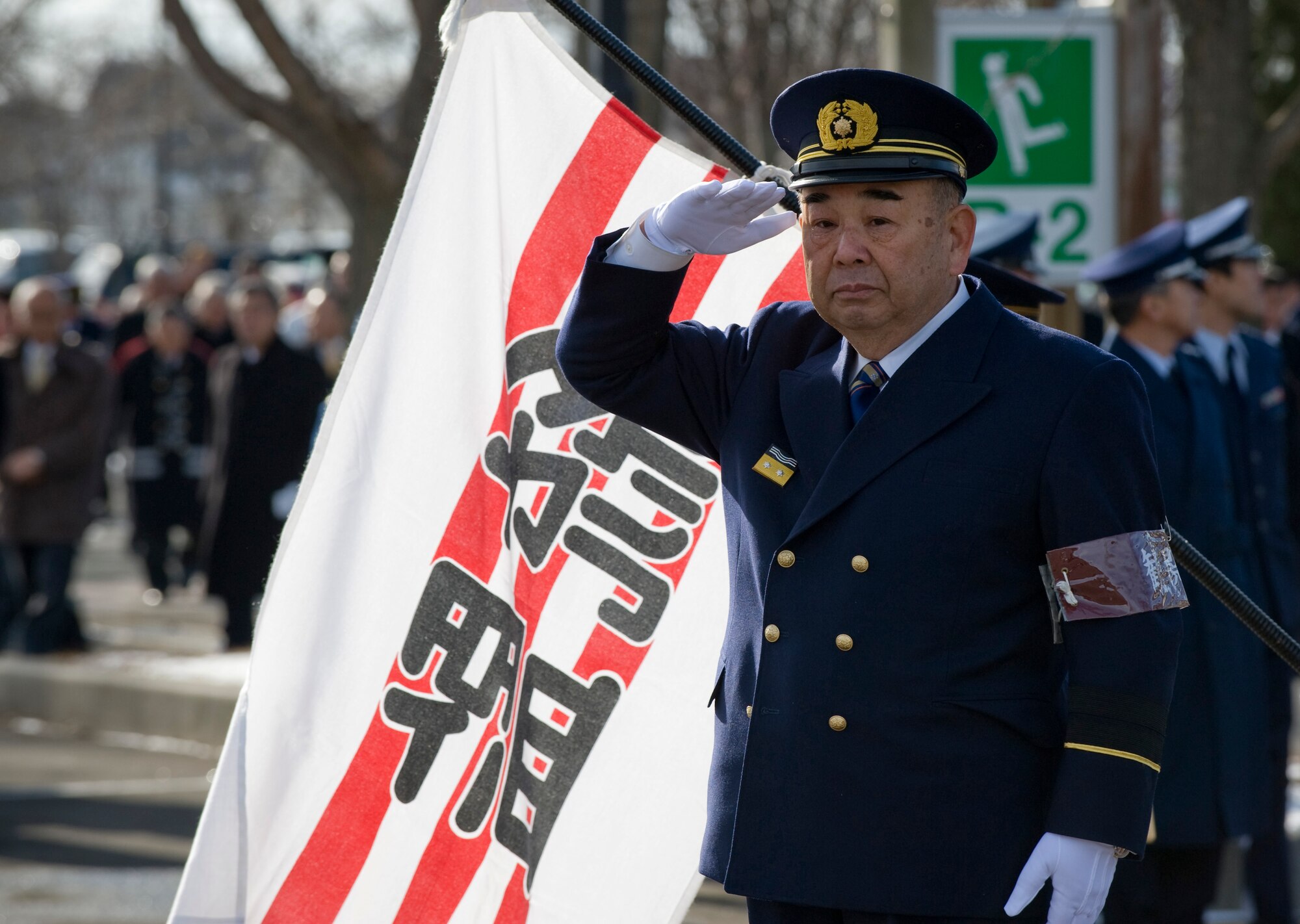 MISAWA CITY, Japan -- Misawa City Mayor Kazumasa Taneichi salutes the Misawa City firefighters at the Misawa Ice Arena Jan. 11. The Misawa City Fire Department and Misawa Air Base held a New Year's ceremony featuring a review of their fire trucks. (U.S. Air Force photo/Staff Sgt. Samuel Morse)