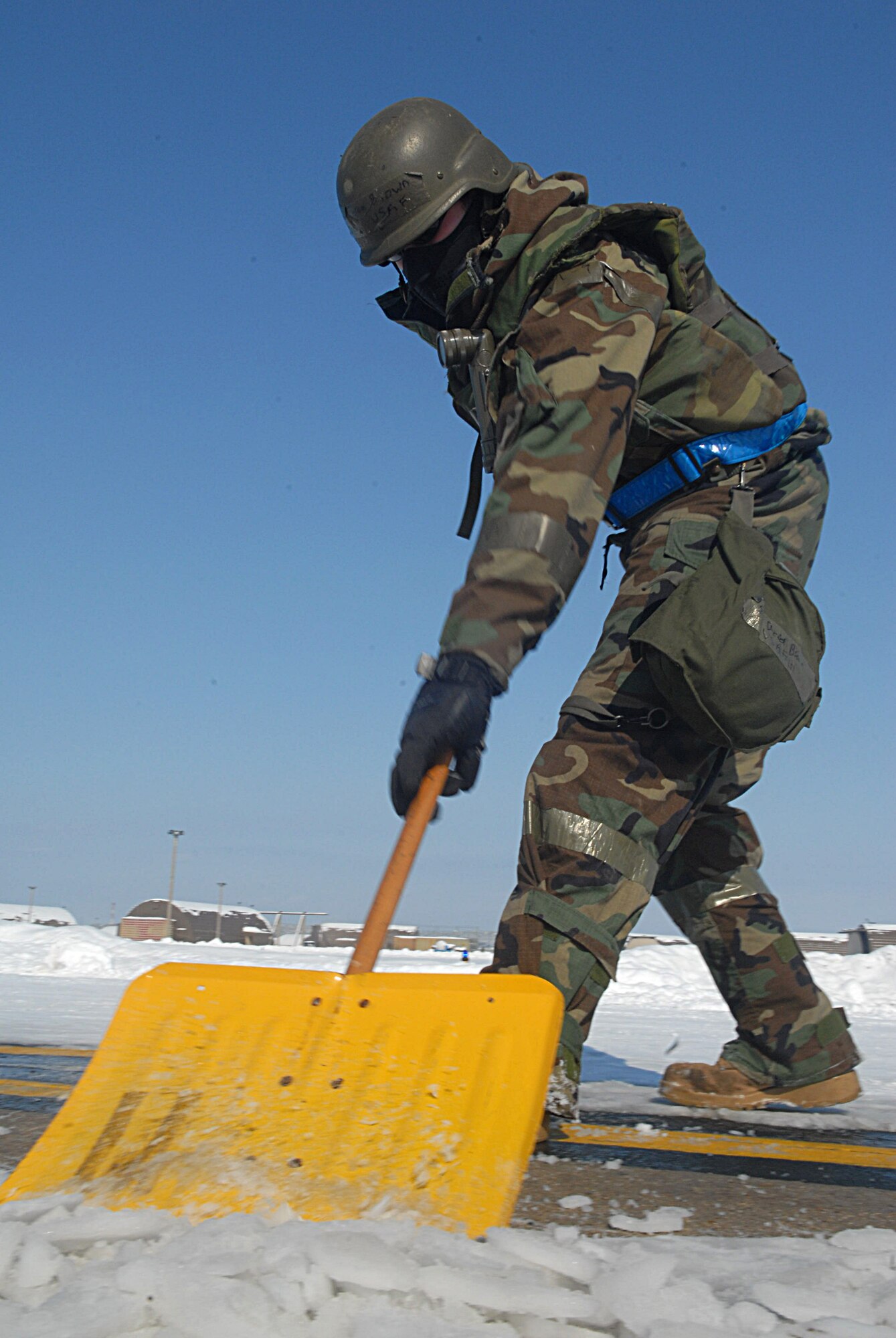 KUNSAN AIR BASE, Republic of Korea -- Staff Sgt. Derek Brown, 8th Maintenance Group weapons load crew chief, removes snow from the runway during the Peninsula-wide Operational Readiness Exercise here, Jan. 14. Kunsan received more than 16 inches of snow, and Airmen cleared it from the flightline, taxiways and hardened shelters within 10 hours to get aircraft in the air to fly missions.  (U.S. Air Force photo/Senior Airman Roy Lynch)