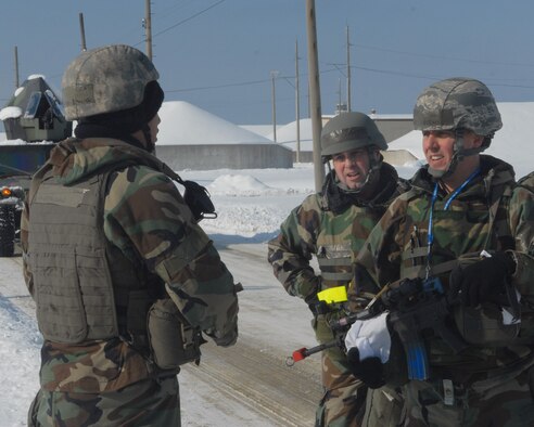 KUNSAN AIR BASE, Republic of Korea -- Col. Rob Givens, 8th Fighter Wing commander, and Chief Master Sgt. James Sanders, 8th FW command chief, talk about strategy and safety with Senior Airman Emile Navarro, 8th Security Forces Squadron, during the Peninsula-wide Operational Readiness Exercise here, Jan. 14. 