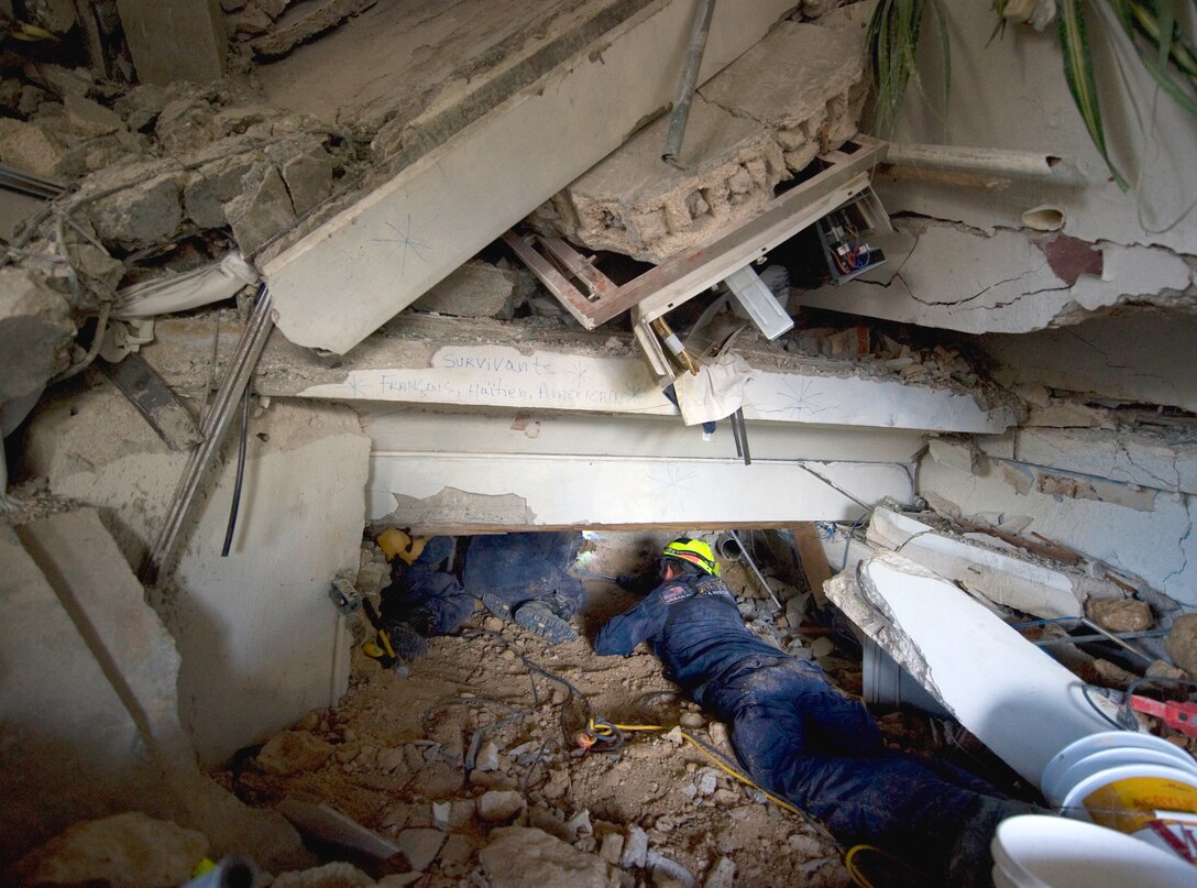 Members of Fairfax County Urban Search and Rescue from Virginia search for earthquake victims at the Montana Hotel in Port-au-Prince, Haiti, Jan. 14, 2010. 