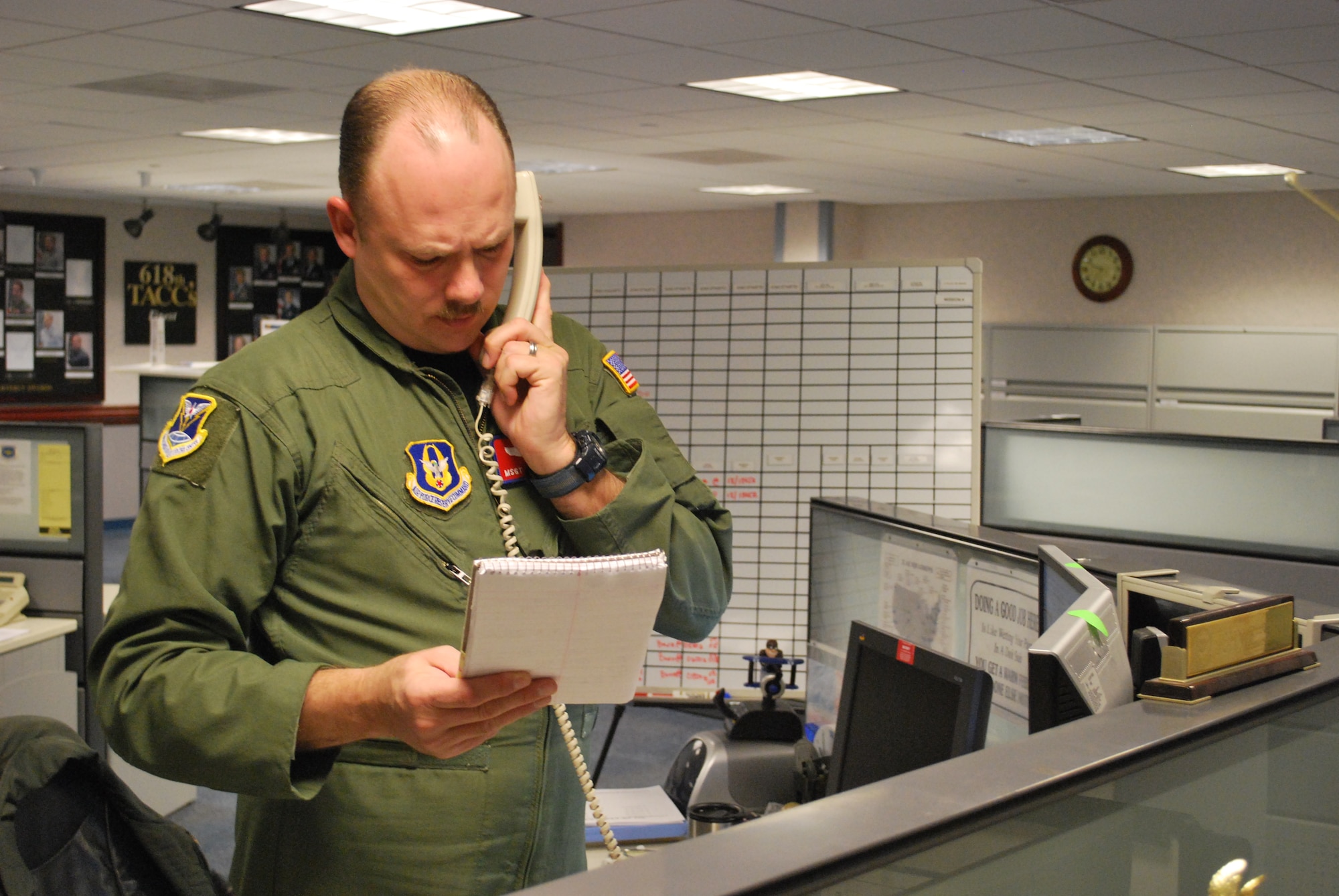 Master Sgt. John Smith, an aeromedical evacuation mission planner from the 618th Tanker Airlift Control Center's Global Readiness Directorate (XOP), discusses AE requirements in Haiti, Jan. 16.  The AE division executes worldwide aeromedical evacuation missions 24/7/365, from the 618th TACC at Scott Air Force Base, Ill.  618th TACC personnel have been working around-the-clock since Tuesday to support U.S. relief efforts in Haiti after a 7.0-magnitude earthquake struck the region. (U.S. Air Force photo/Capt. Justin Brockhoff)
