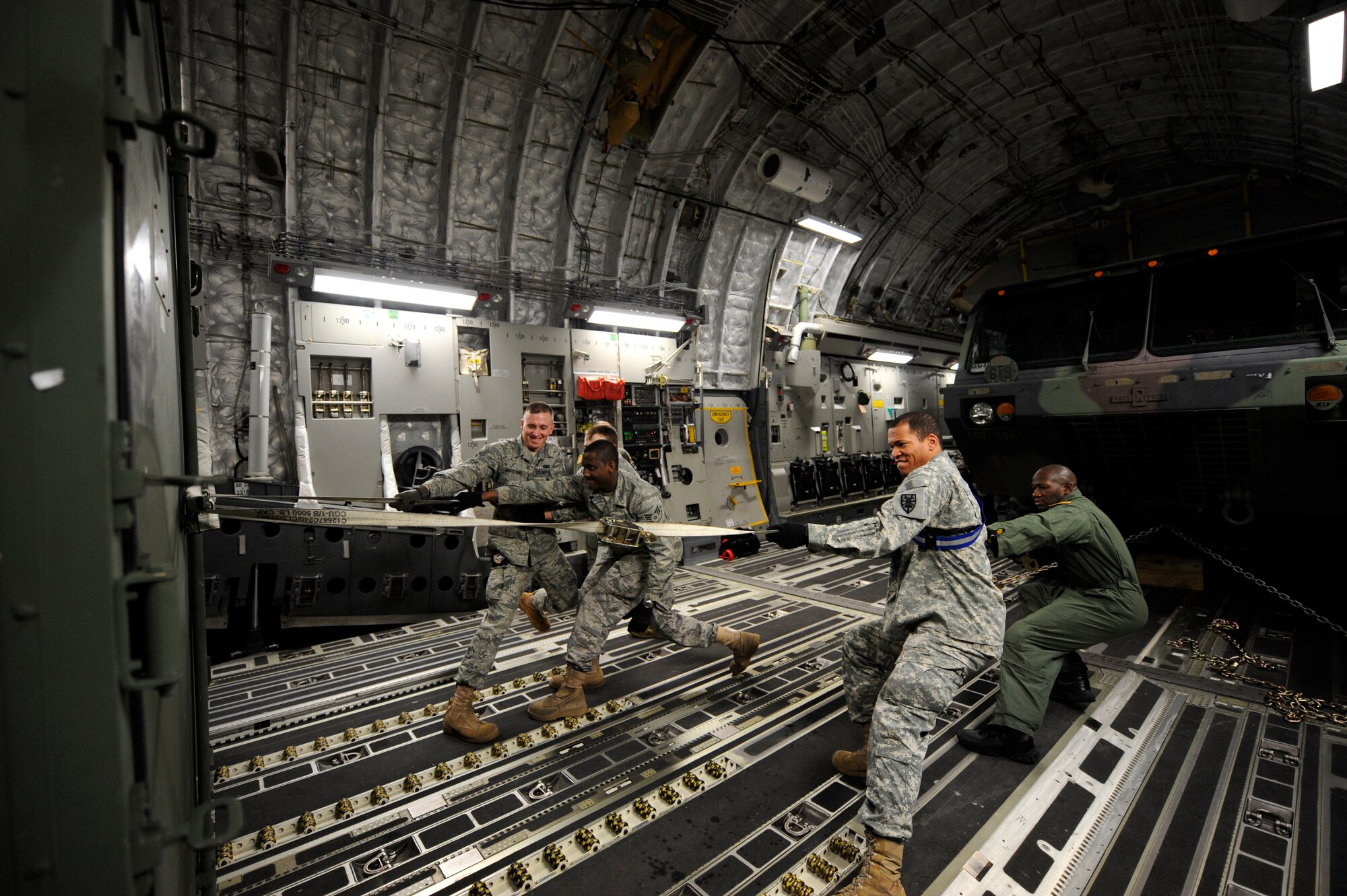 LANGLEY AIR FORCE BASE, Va. – United States Air Force and Army personnel load cargo onto a C-17 Globemaster III cargo aircraft Jan. 16. Air Force and Army personnel from Langley and Fort Eustis, Va., loaded equipment and supplies onto the aircraft to support relief efforts, save lives and alleviate human suffering following the devastating earthquake that struck Haiti on Jan. 12. (U.S. Air Force photo/ Senior Airman Dana Hill)