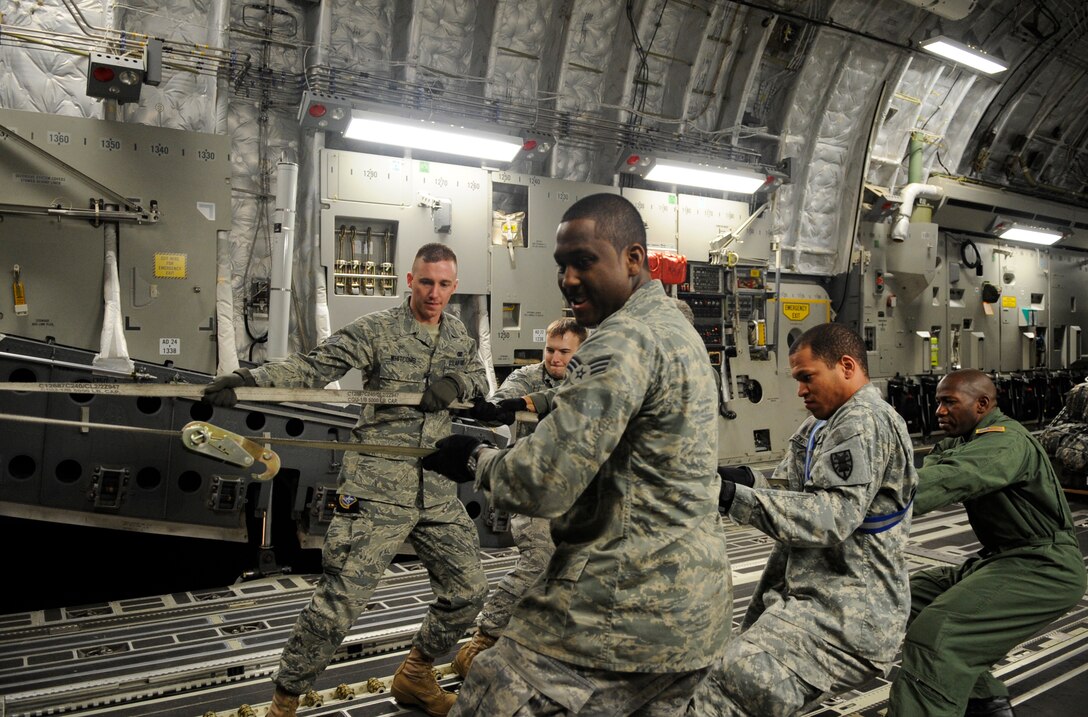 LANGLEY AIR FORCE BASE, Va. – United States Air Force and Army personnel load cargo onto a C-17 Globemaster III cargo aircraft Jan. 16. Air Force and Army personnel from Langley and Fort Eustis, Va., loaded equipment and supplies onto the aircraft to support relief efforts, save lives and alleviate human suffering following the devastating earthquake that struck Haiti on Jan. 12. (U.S. Air Force photo/ Senior Airman Dana Hill)