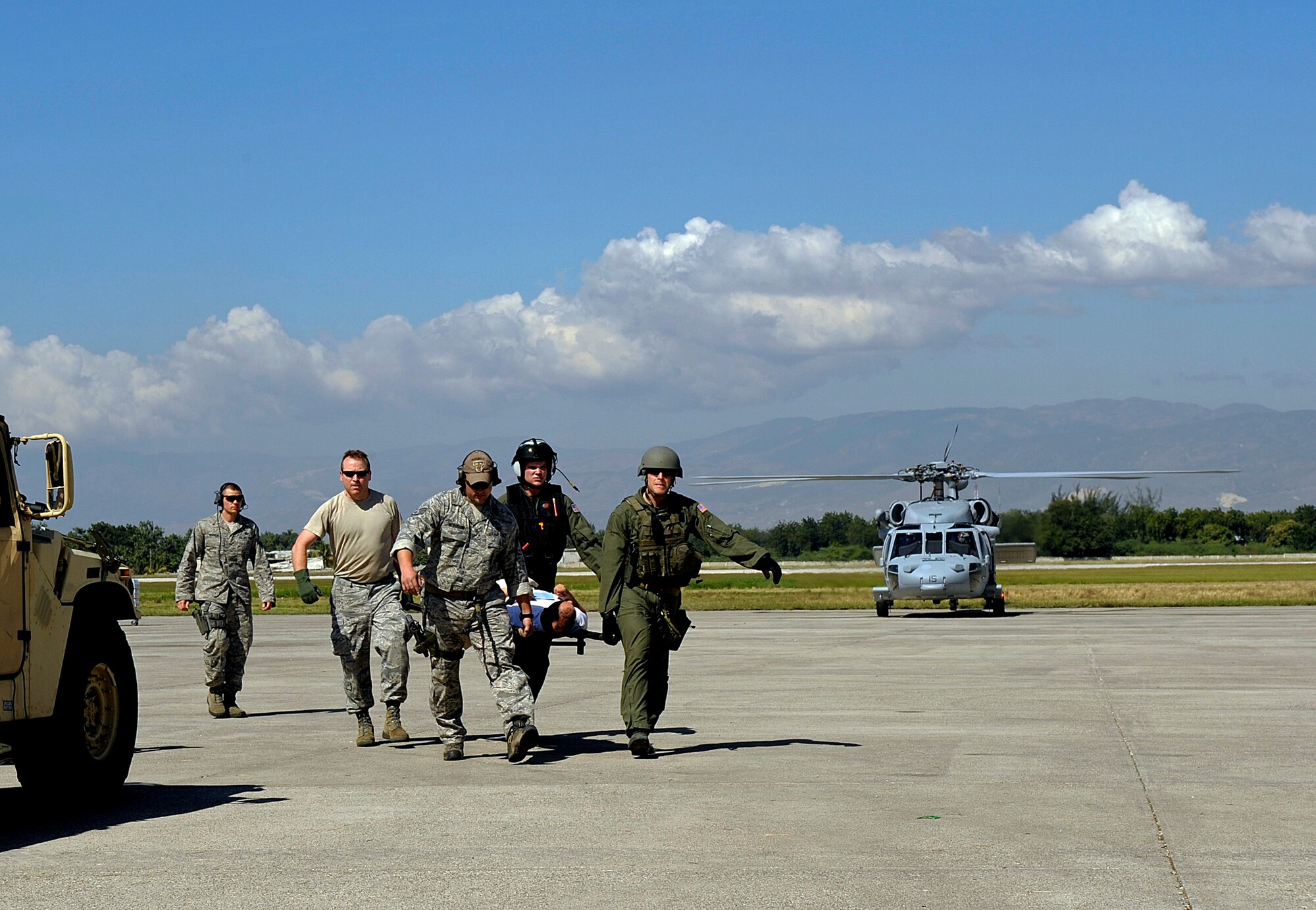 U.S. Airmen from the Air Force Special Operations Command (AFSOC), Hurlburt Field, Fla., offload injured people from a C-130 Hercules aircraft Jan. 15, 2010, after the earthquake in Port-au-Prince, Haiti. AFSOC is providing an immediate rapid response capability to Haiti through U.S. Southern Command. (U.S. Air Force photo by Master Sgt. Russell E. Cooley IV/Released)