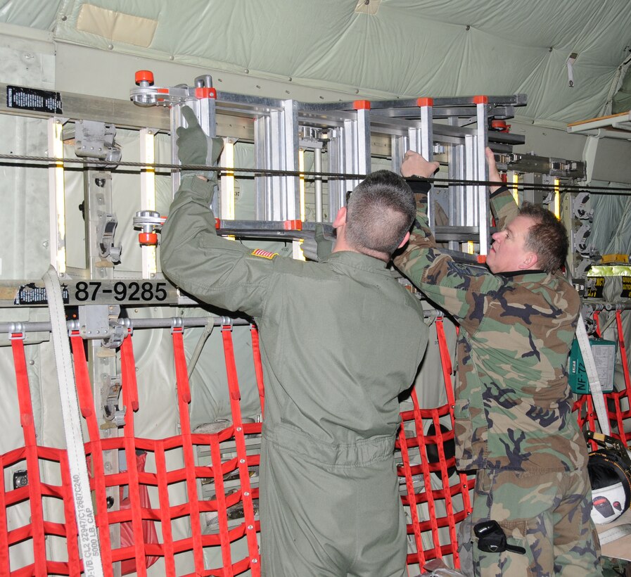The 107th Airlift Wing, New York Air National Guard along with the 914th Airlift Wing, Air Force Reserves were tasked to send two fully crewed C-130s to aid in the humanitarian efforts in Haiti. In the early morning hours of Jan. 16, (on left) Master Sgt. Scott Dixon, 107th AW C-130 Loadmaster and Master Sgt. Ronald Szpaicher, 107th AW C-130 Crew Chief secured the cargo area for take-off. The Two sergeants will spend the next five days airlifting supplies in to the affected area.   
"We're going down to help people in dire need right now," said Sgt. Szpaicher.  "We're trying to give the people some kind of comfort and relief," he added. 

