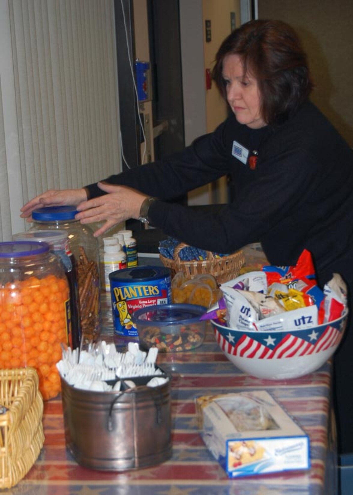 USO volunteer Vera Cianciotto sets out snacks at the Dover Air Force Base terminal for people preparing to perform a dignified transfer. (U.S. Air Force photo by Ed Drohan, AFMAO/PA) 