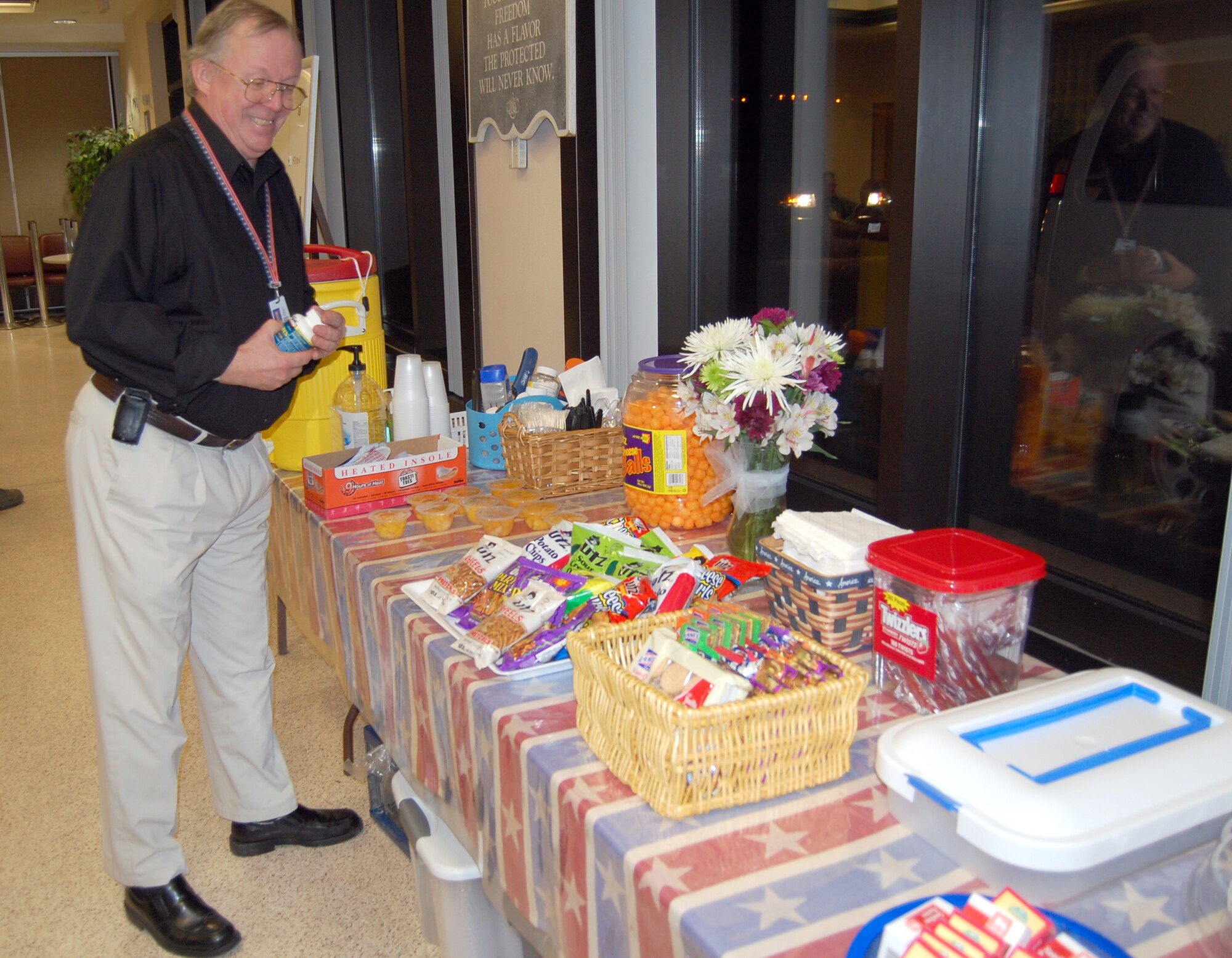 Dave Wilson, a USO volunteer, ensures everything is set up at the Dover Air Force Base passenger terminal in preparation for a dignified transfer. (U.S. Air Force photo by Ed Drohan, AFMAO/PA)
