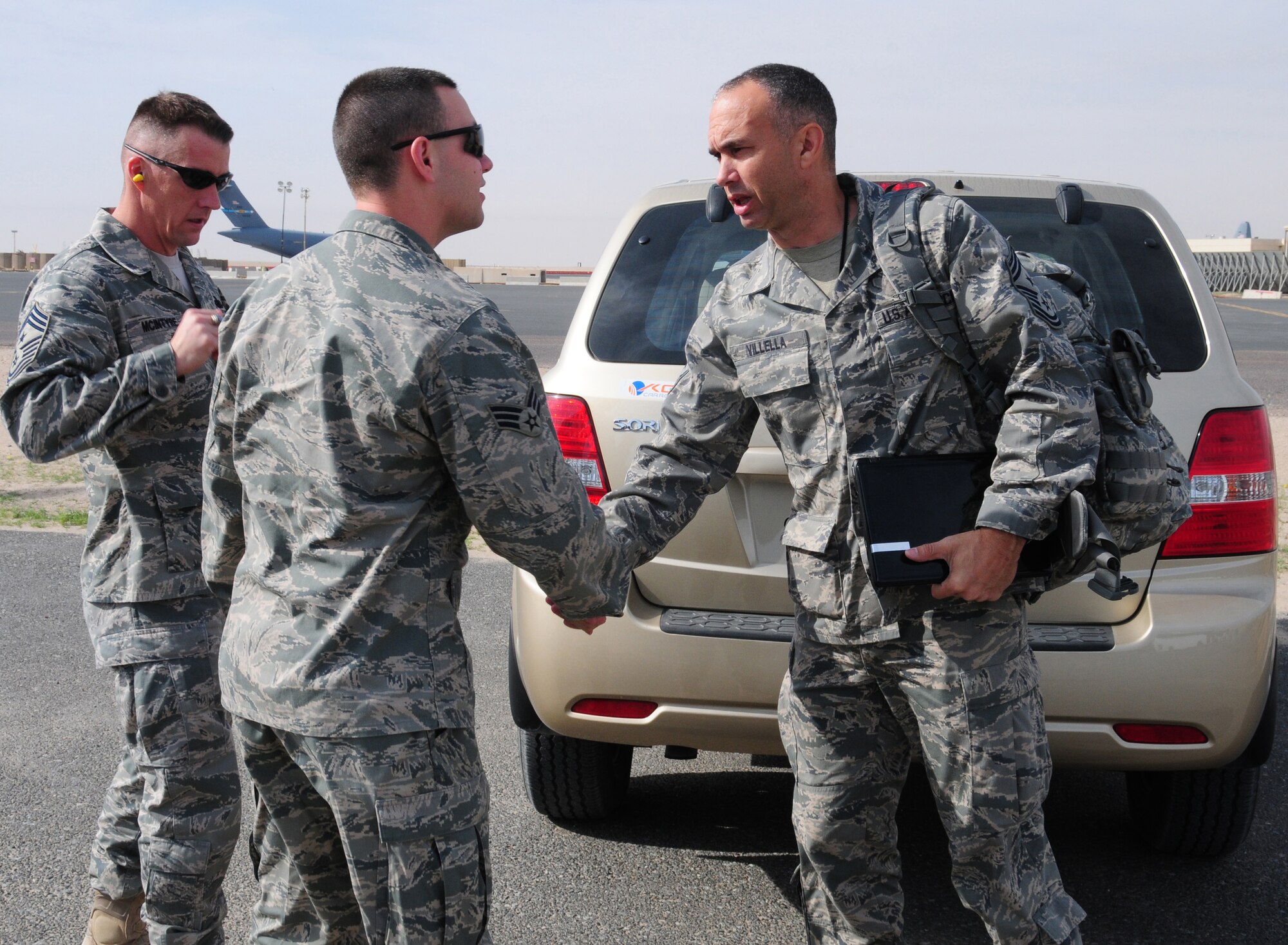Chief Master Sgt. Mark Villella, U.S. Air Forces Central command chief master sergeant, thanks Senior Airman Andrew Boyd, 386th Air Expeditionary Wing Protocol, for helping to ensure a great three-day tour of an air base in Southwest Asia, affectionately known as "The Rock" Jan. 15, 2010. (U.S. Air Force photo by Staff Sgt. Lakisha A. Croley/Released)