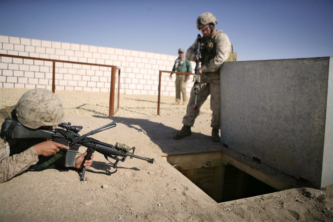 Searching for a simulated captured comrade, Weapons Platoon Marines prepare to enter a hidden tunnel system during counterinsurgency training at Forward Operating Base Gerber here Jan. 16. The tunnel led to an underground chamber housing the captured Marine. The Marines of Company G later found the Marine after building trust and gathering intelligence from role players portraying Afghans. The company’s Marines serve as the mechanized assault force for the 11th Marine Expeditionary Unit’s ground combat element, Battalion Landing Team 2/4, aka the Magnificent Bastards.