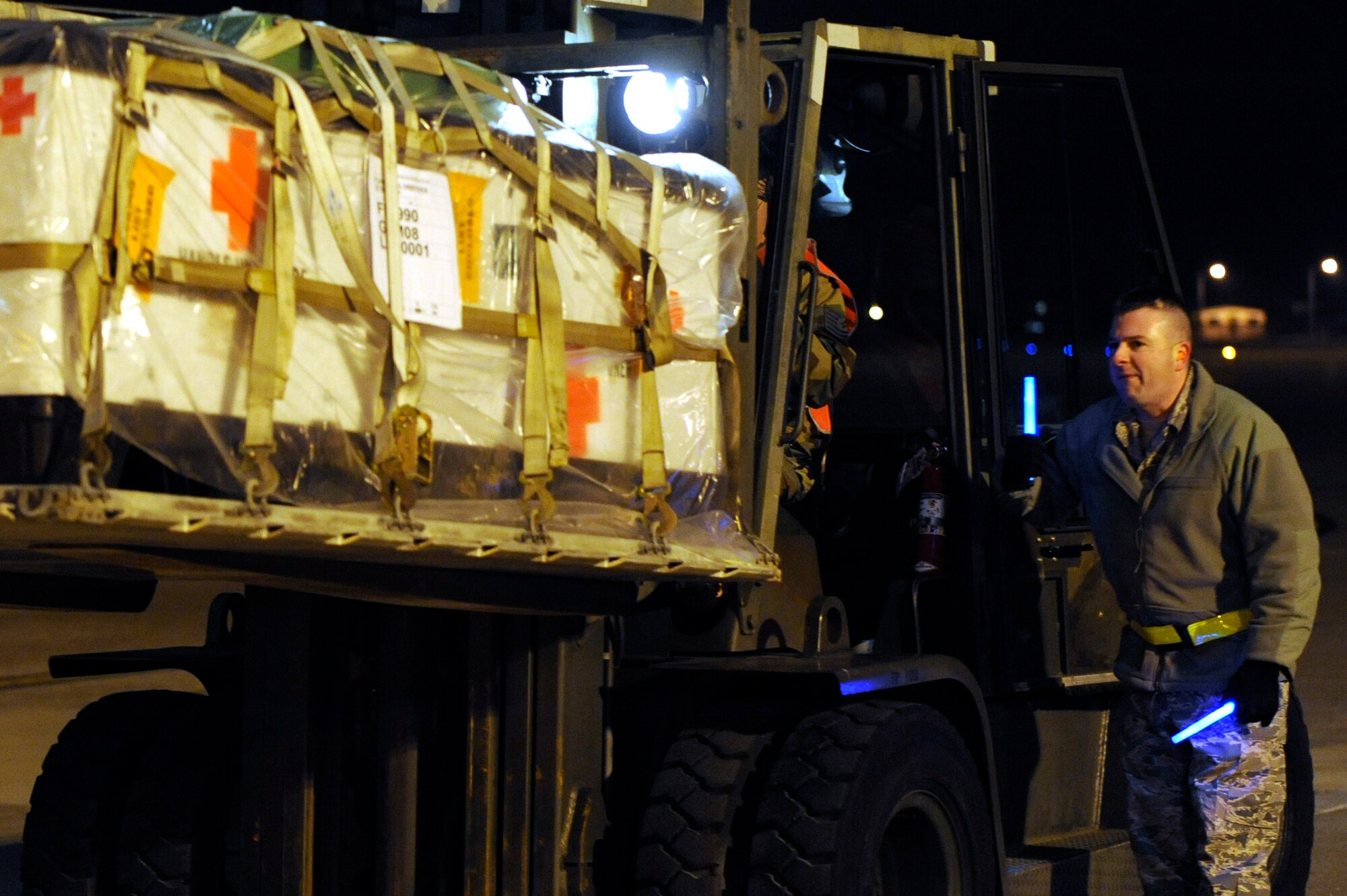 Tech. Sgt. Shane Harmon, 375th Logistics Readiness Squadron air transportation craftsman, guides a forklift carrying medical supplies onto a C-17 aircraft bound for Haiti Jan. 17, 2010. The C-17, along with more than 40,000 pounds of medical supplies and aeromedical teams from the 375th Air Mobility Wing and U.S.Transportation Command, is headed to Haiti to deliver medical support in the wake of the recent earthquake. (U.S. Air Force photo/ Senior Airman Wesley Farnsworth)