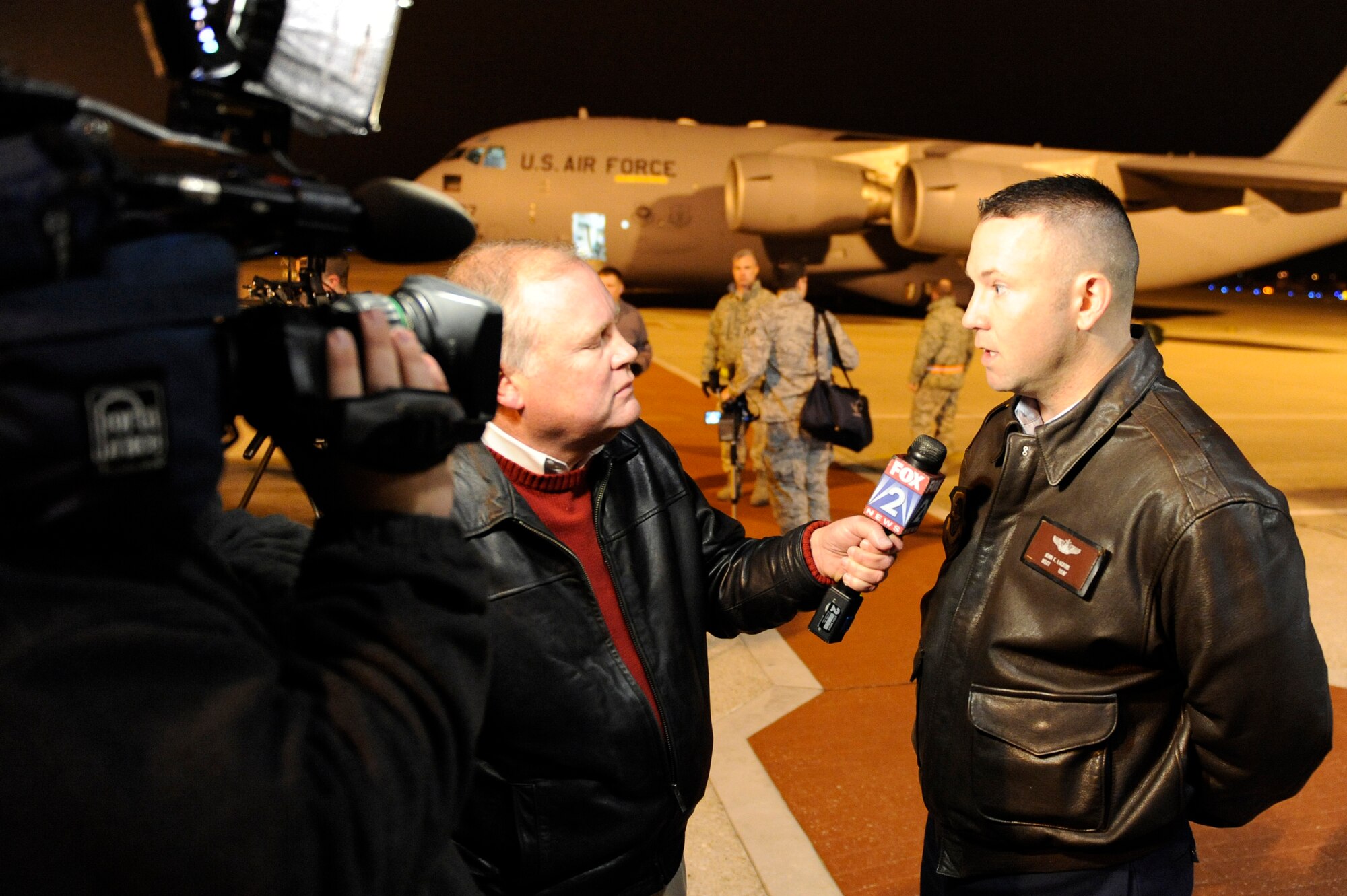 Fox 2 news reporter Roche Madden interviews Master Sgt. John Lacroix, 618th Tanker Airlift Control Center manager aeromedical division, on the runway of Scott, Jan. 17, 2010, about the mission the C-17 aircraft behind them is about to embark on. The C-17 along with it’s more than 40,000 pounds of medical supplies are headed to the Haiti to provide medical relief in the wake of the recent earthquake. Aeromedical Evacuation crews from both the 375th Air Mobility Wing and U.S. Transportion Command were also on board. (U.S. Air Force photo/ Senior Airman Wesley Farnsworth)