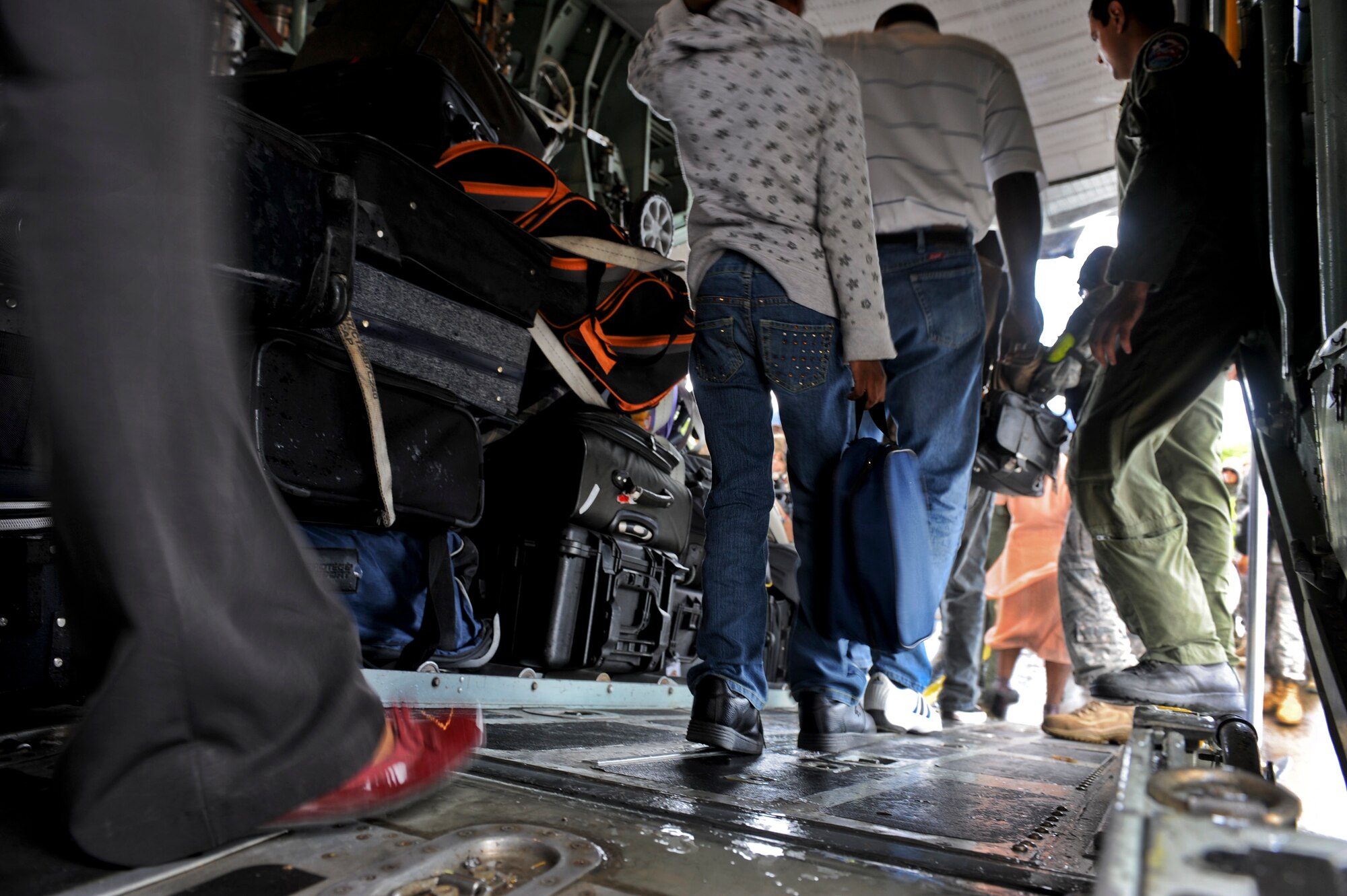 Airmen from the Puerto Rico Air National Guard’s 156th Airlift Wing assist U.S. citizens off a C-130E Hercules aircraft Jan. 17, that landed in San Juan, Puerto Rico. The American citizens were evacuated from Haiti where Airmen are playing an active role in support of the relief effort there in the aftermath of a devastating earthquake. (U.S. Air Force photo/Staff Sgt. Desiree N. Palacios)