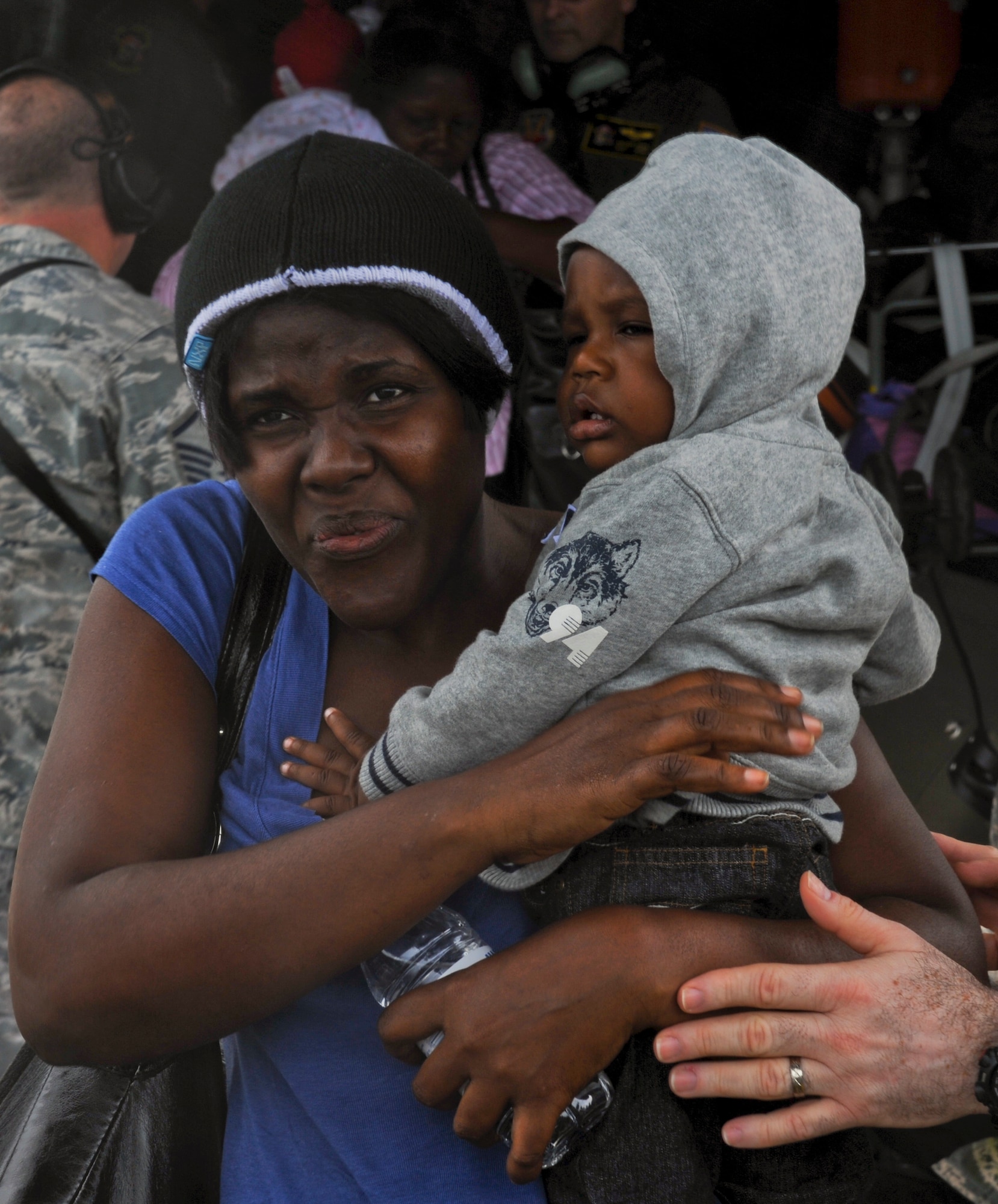 U.S. citizens leave a Puerto Rico Air National Guard C-130E Hercules aircraft Jan. 17, that landed in San Juan, Puerto Rico. The American citizens were evacuated from Haiti where Airmen are playing an active role in support of the relief effort there in the aftermath of a devastating earthquake. (U.S. Air Force photo/Staff Sgt. Desiree N. Palacios)