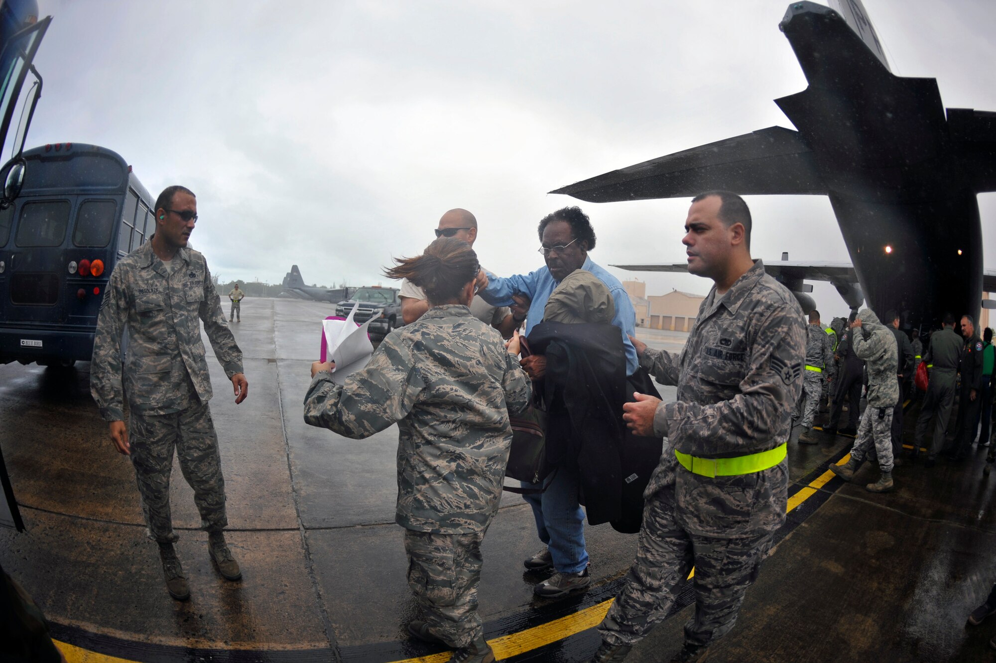 Airmen from the Puerto Rico Air National Guard’s 156th Airlift Wing assist U.S. citizens after being transported by a C-130E Hercules aircraft Jan. 17, that landed in San Juan, Puerto Rico. The American citizens were evacuated from Haiti where Airmen are playing an active role in support of the relief effort there in the aftermath of a devastating earthquake. (U.S. Air Force photo/Staff Sgt. Desiree N. Palacios)